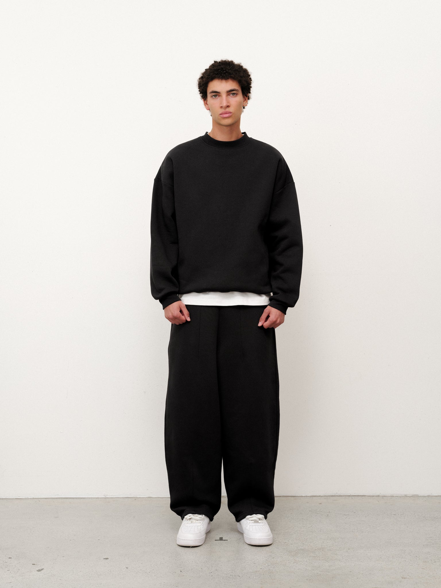 Black cozy sweater from Sweats EU, featuring a soft knit fabric and relaxed fit, displayed on a mannequin.