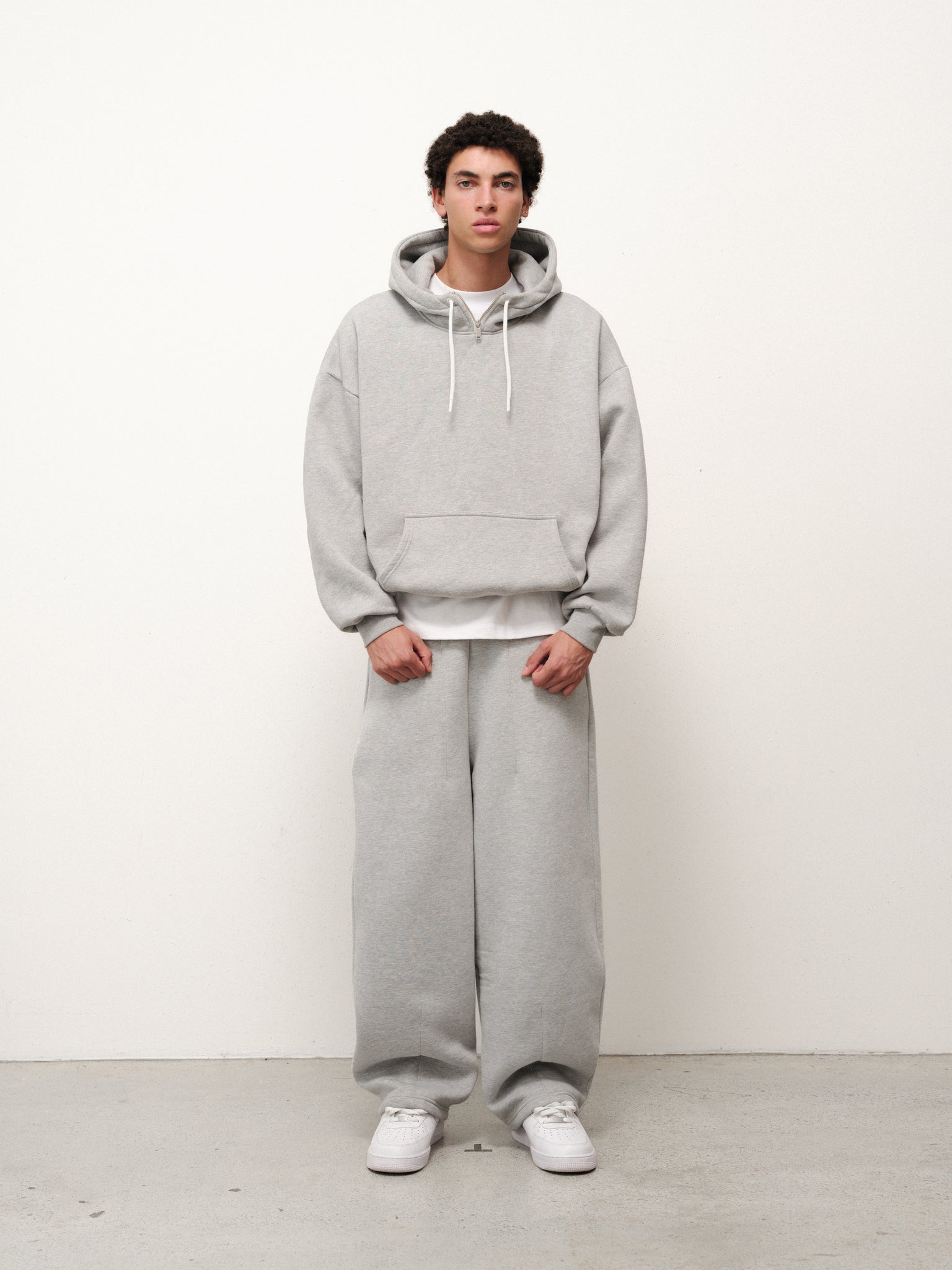 Grey Cozy Tech Hoodie by SWEATS EU, showing the front view with a relaxed fit and adjustable drawstrings.