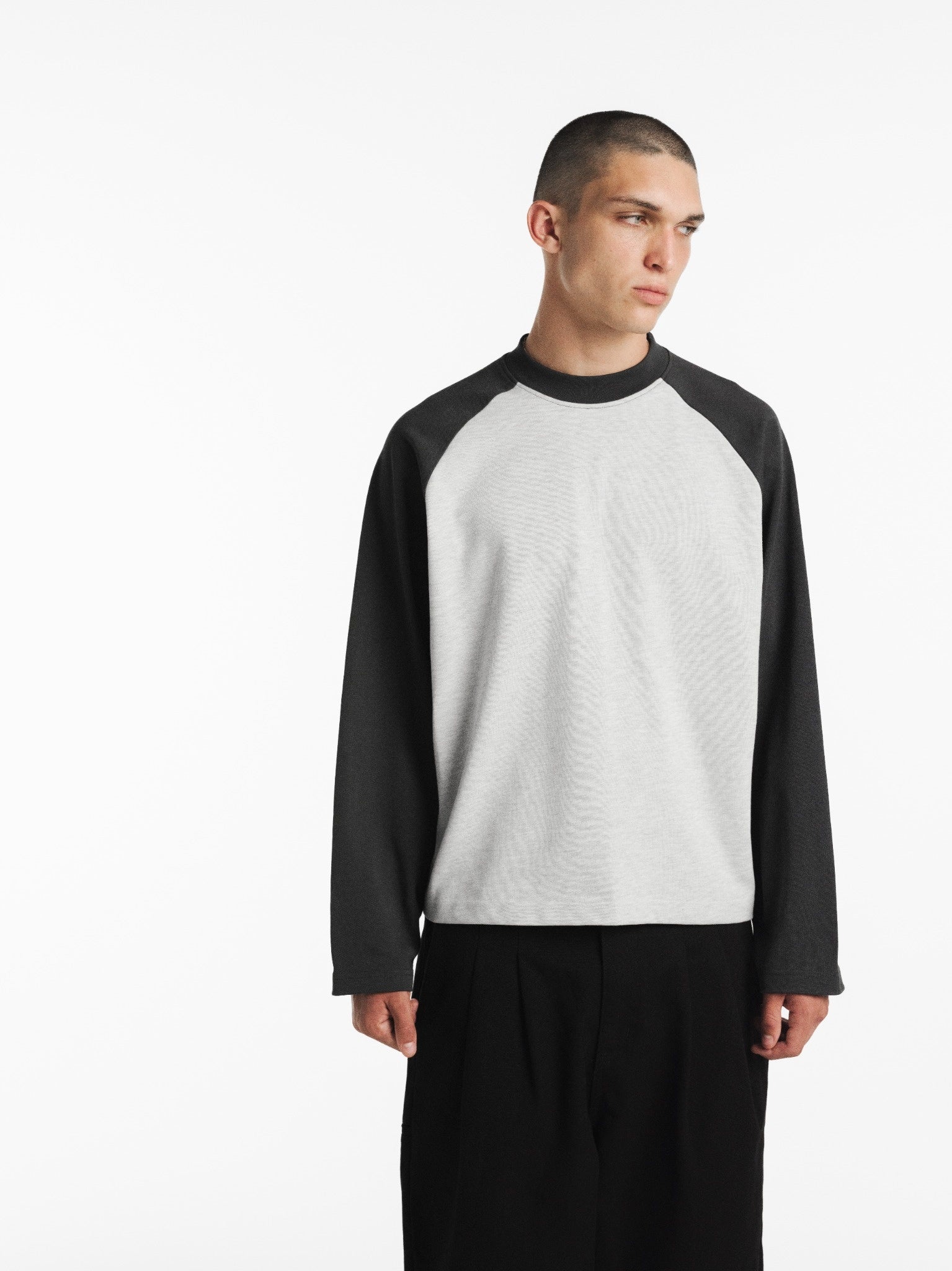 Long-sleeve raglan T-shirt by SWEATS EU in Arctic and Granite color, shown on a model with casual styling.