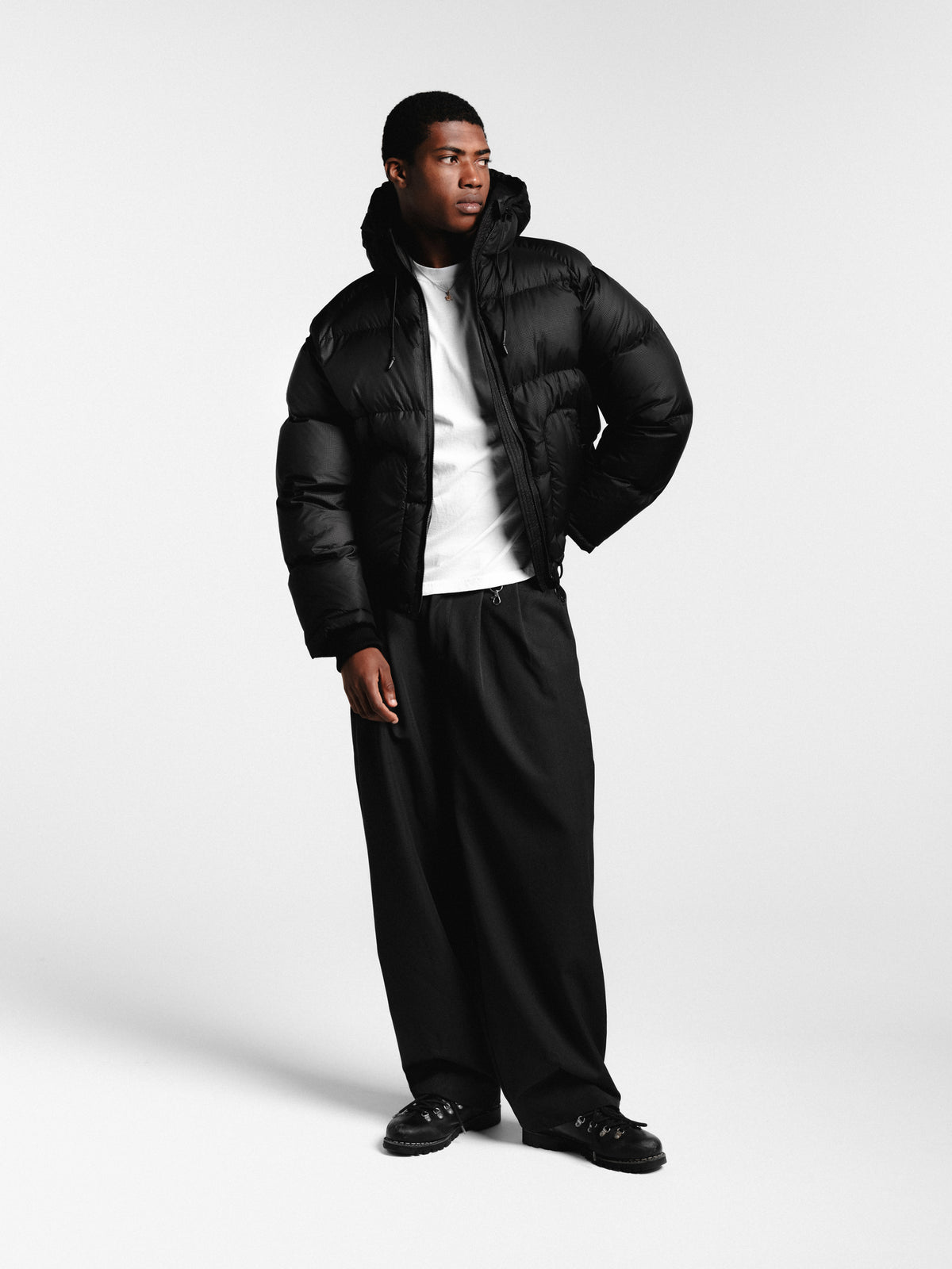 Black pleated pants from Sweats EU, showing the front view with pleats and a tailored fit.