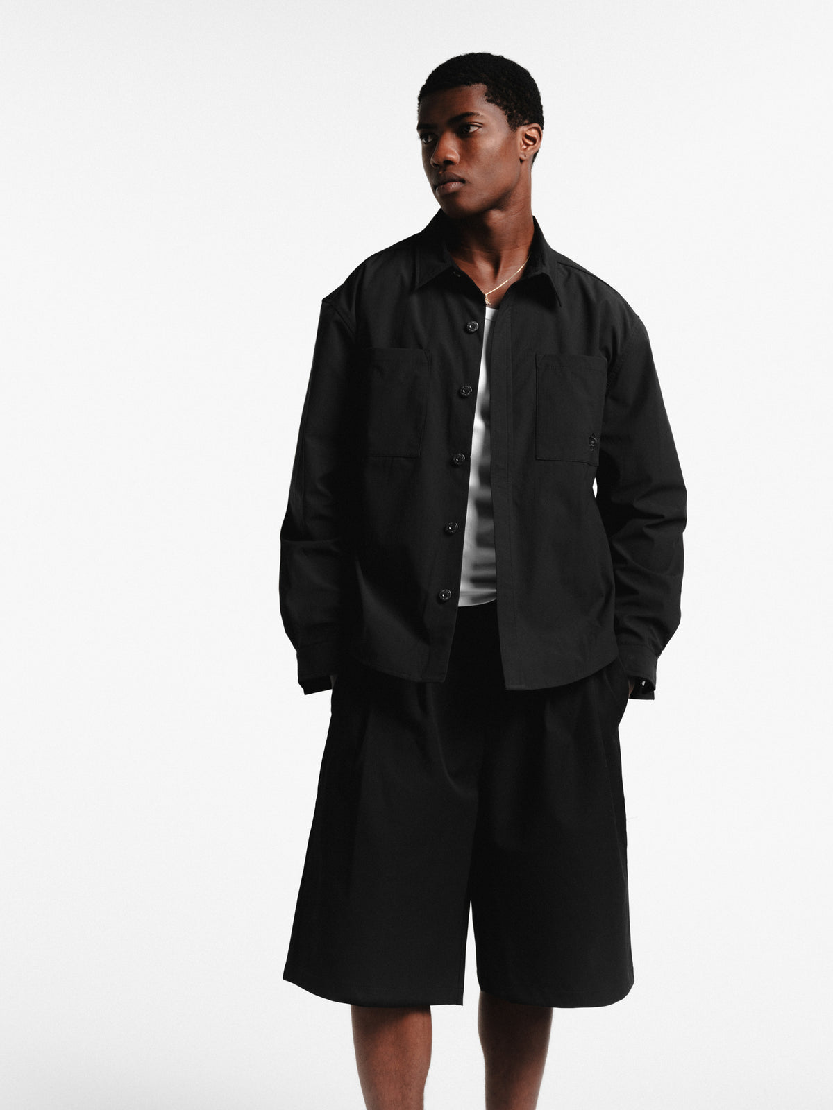 Black pleated shorts by Sweats EU featuring a stylish, high-waisted design and relaxed fit, perfect for casual wear.