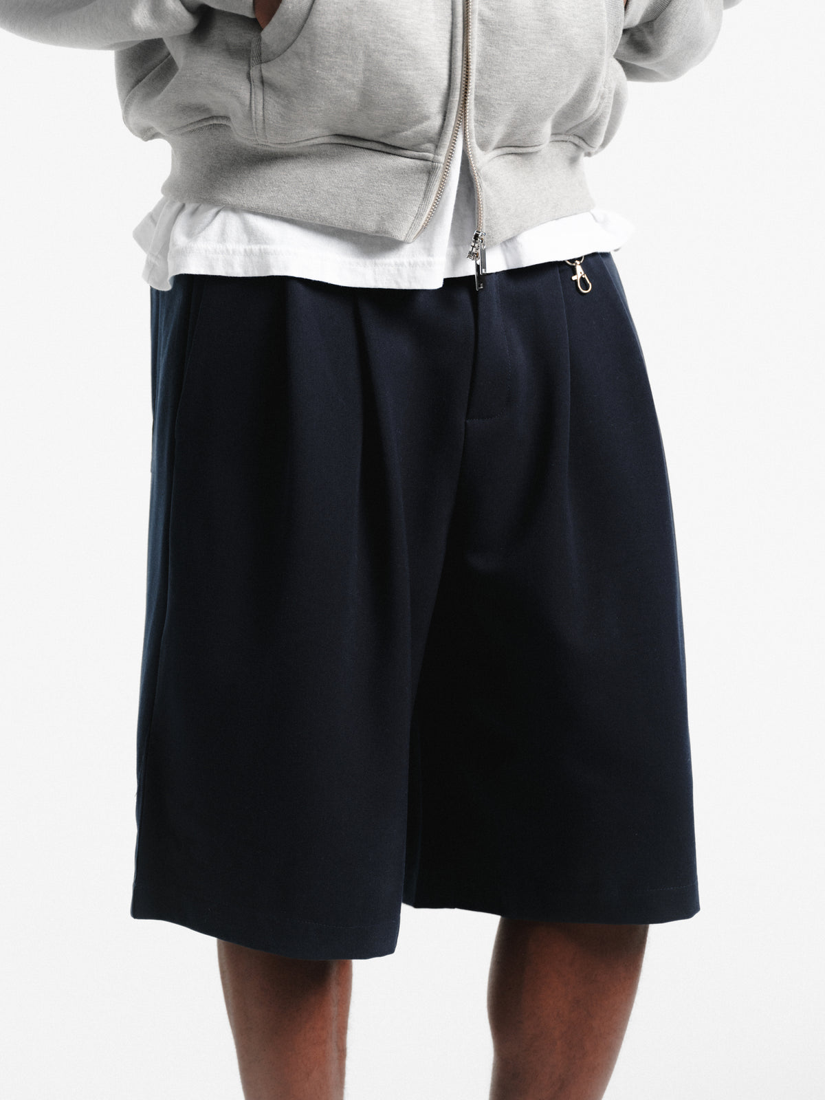 Navy pleated shorts from Sweats EU featuring a stylish, casual design and comfortable fit.