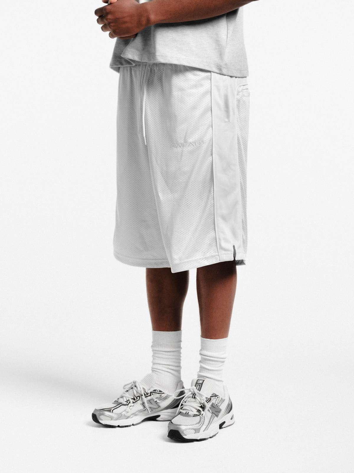 White mesh shorts by SWEATS EU, featuring lightweight fabric and a casual fit, ideal for active or relaxed wear.