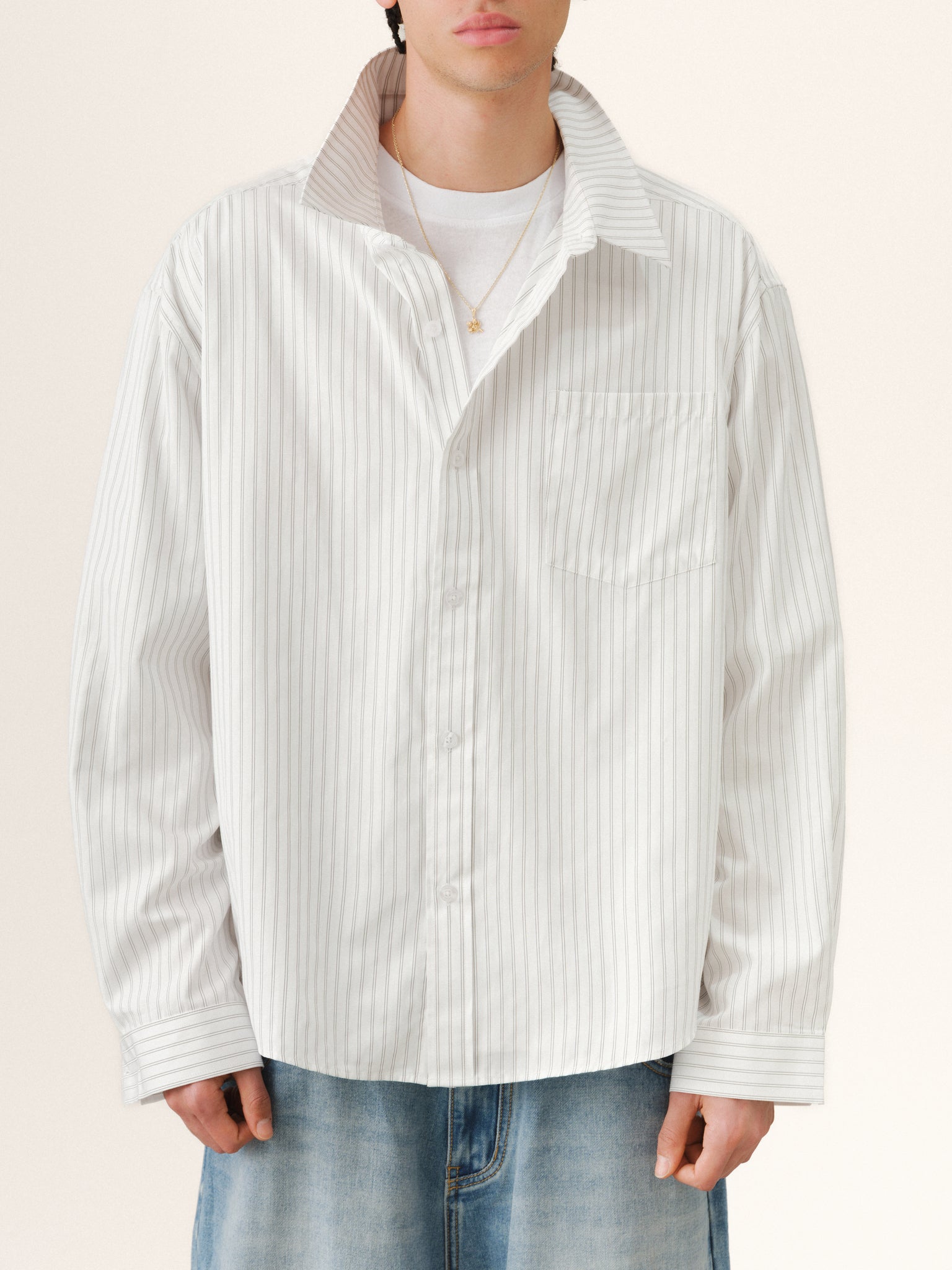 White striped button-up shirt from SWEATS EU, shown laid flat with collar and long sleeves, perfect for casual summer style.