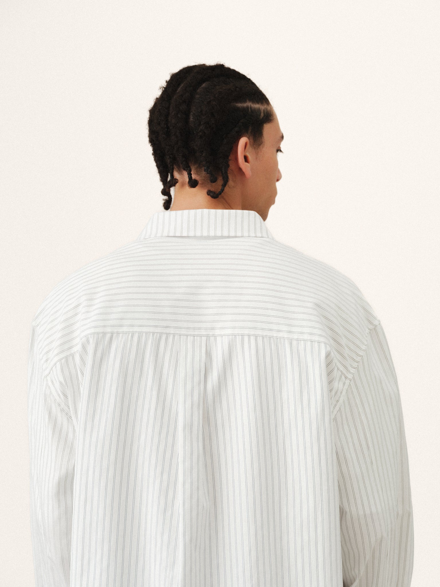 White striped button-up shirt by SWEATS EU featuring a classic collar and long sleeves, displayed flat on a neutral background.