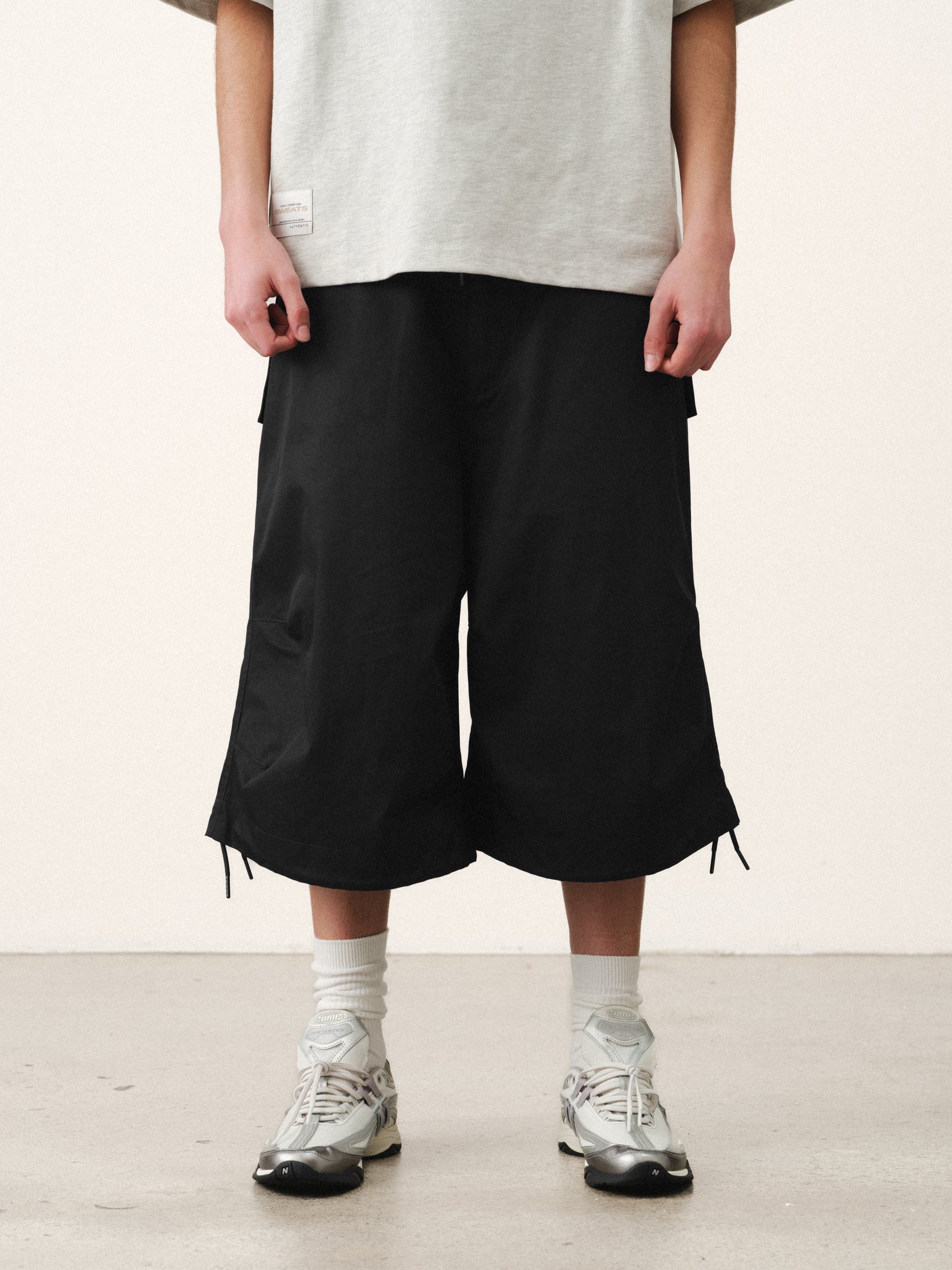 Black V3 Flight Shorts by Sweats EU laid flat, showing lightweight fabric and adjustable waistband for men's activewear.
