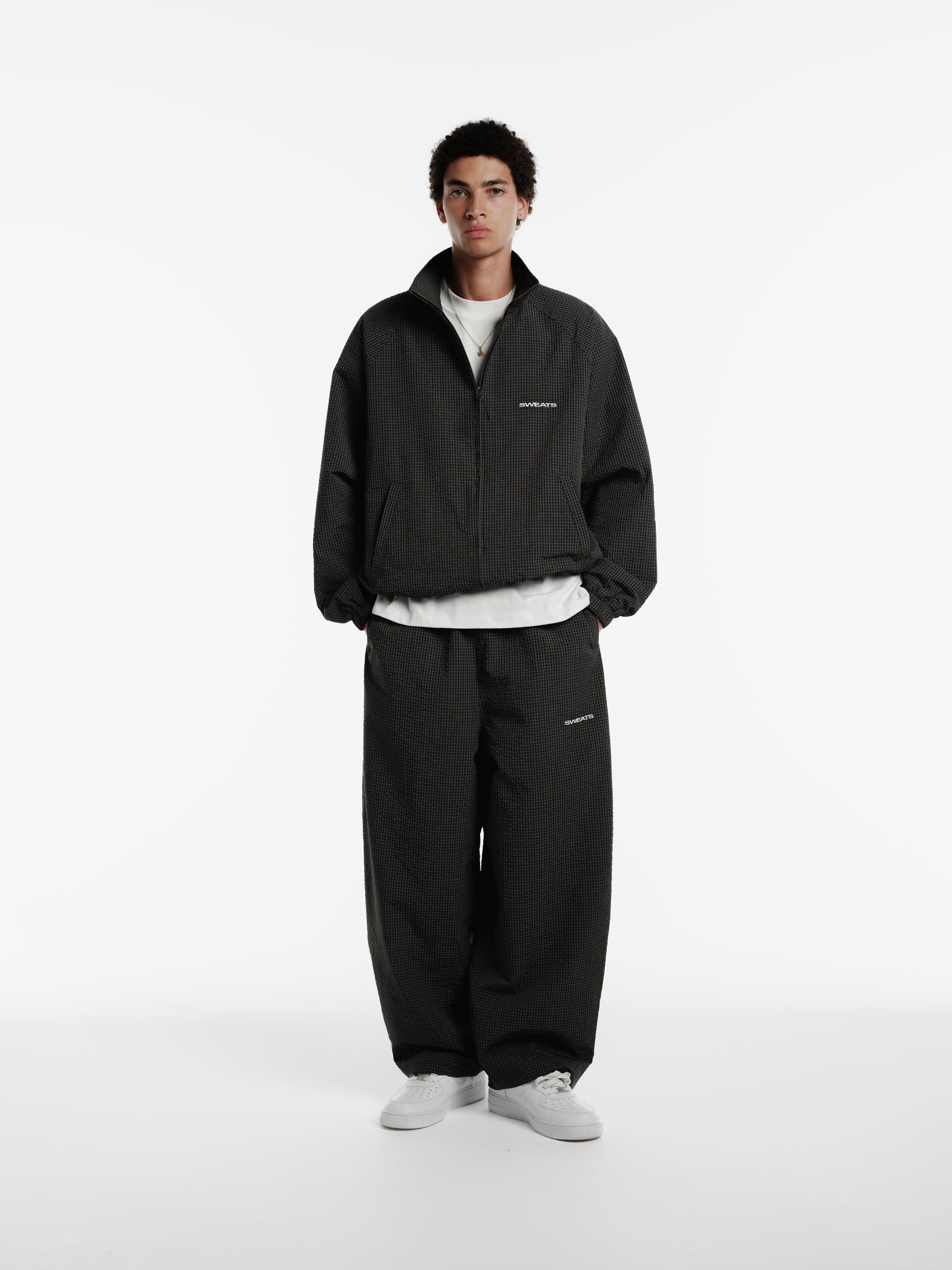 Black and white checkered track jacket by Sweats EU, featuring a sporty design and comfortable fit.