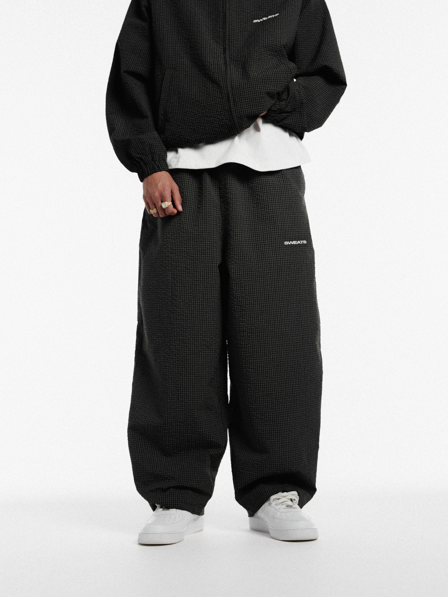 Black and white checkered track pants by Sweats EU, featuring a comfortable fit and sporty style.