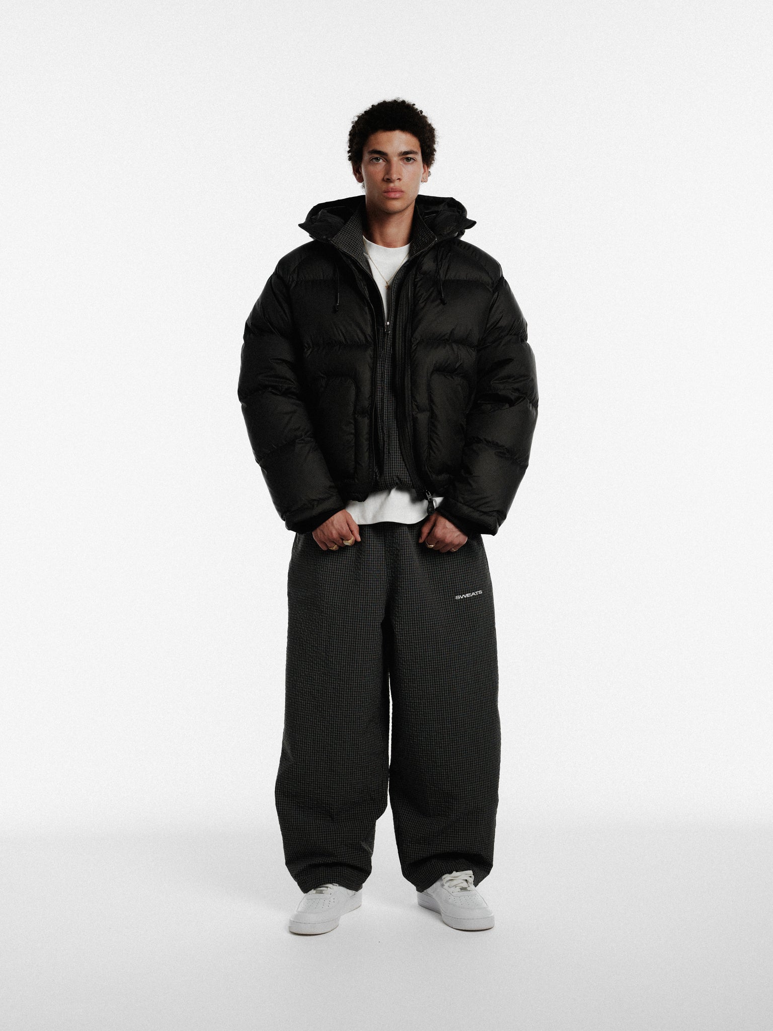 Black and white checkered track pants by Sweats EU, showing a close-up of the stylish, comfortable athletic pants with a relaxed fit.