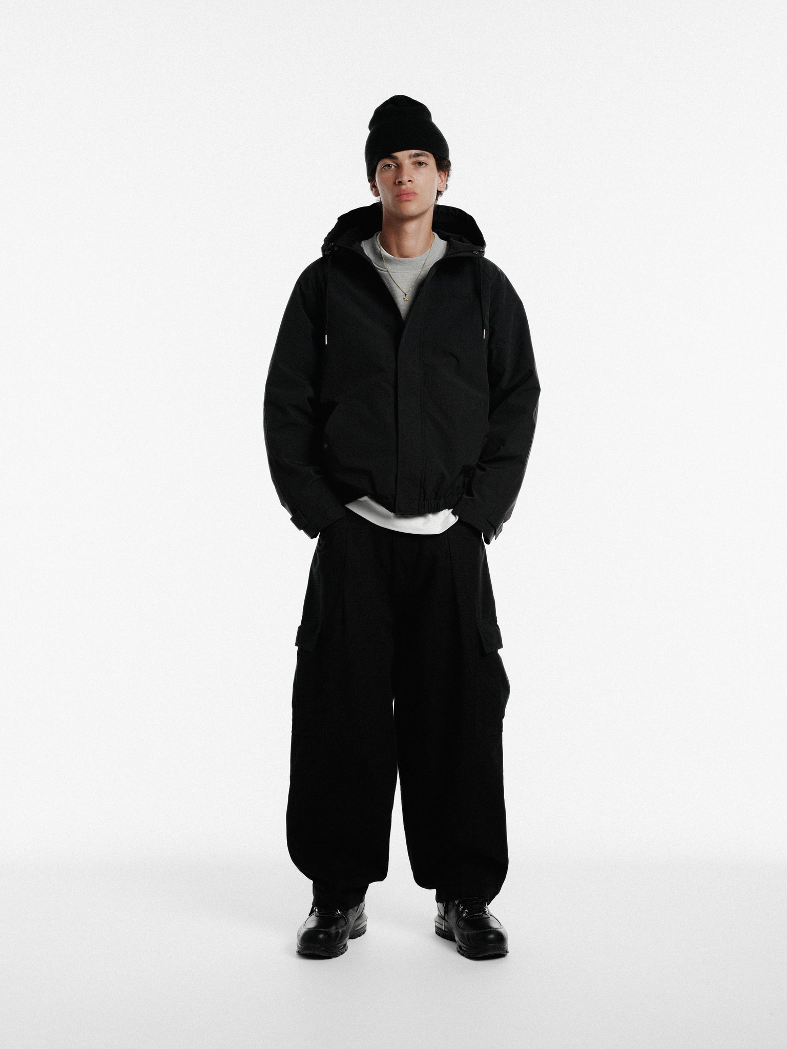 Black ARC Jacket by SWEATS EU, shown in winter style with front zipper and modern fit.