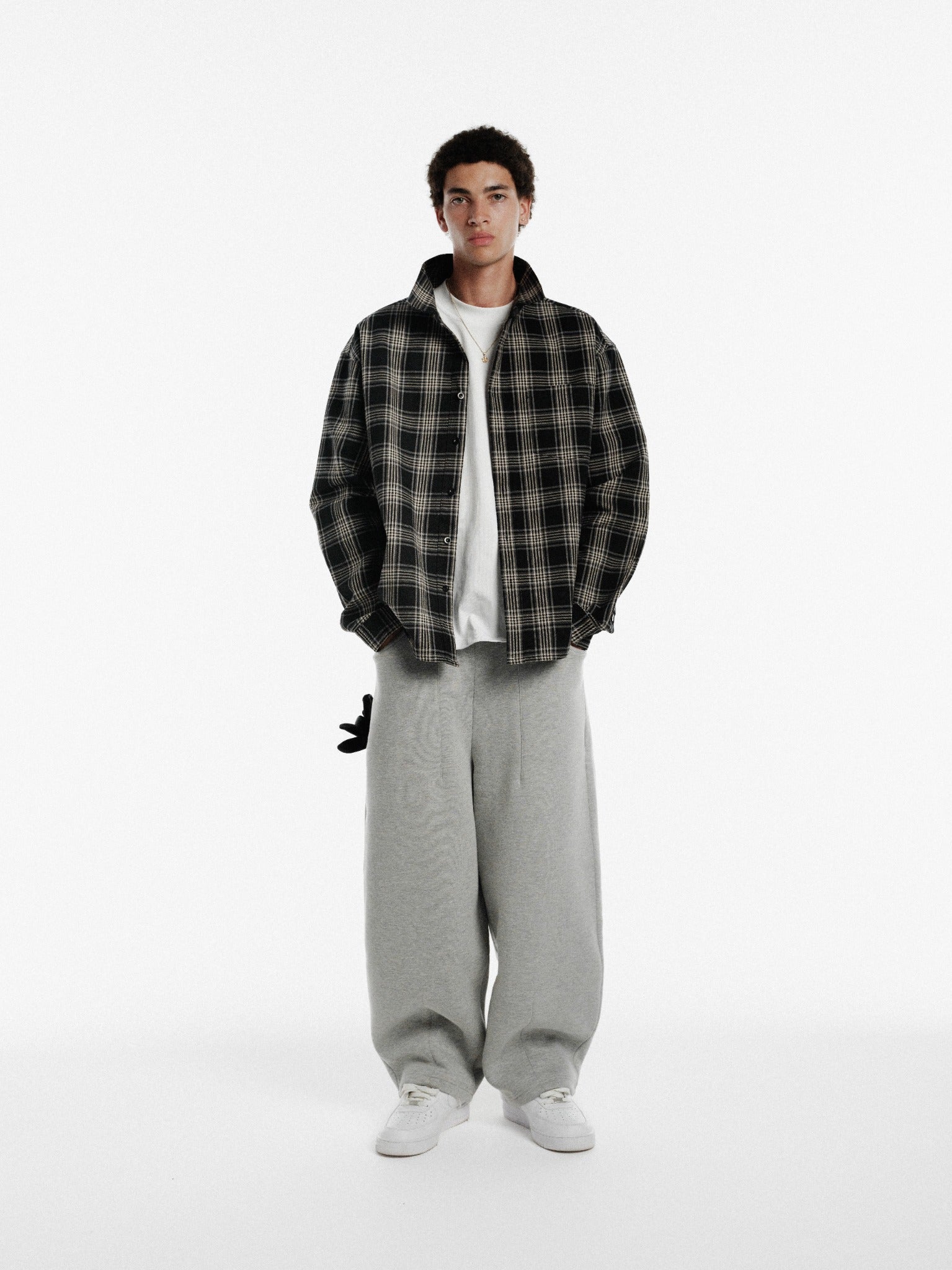 Black flannel long-sleeve shirt by SWEATS EU, shown laid flat with button details and classic plaid pattern.