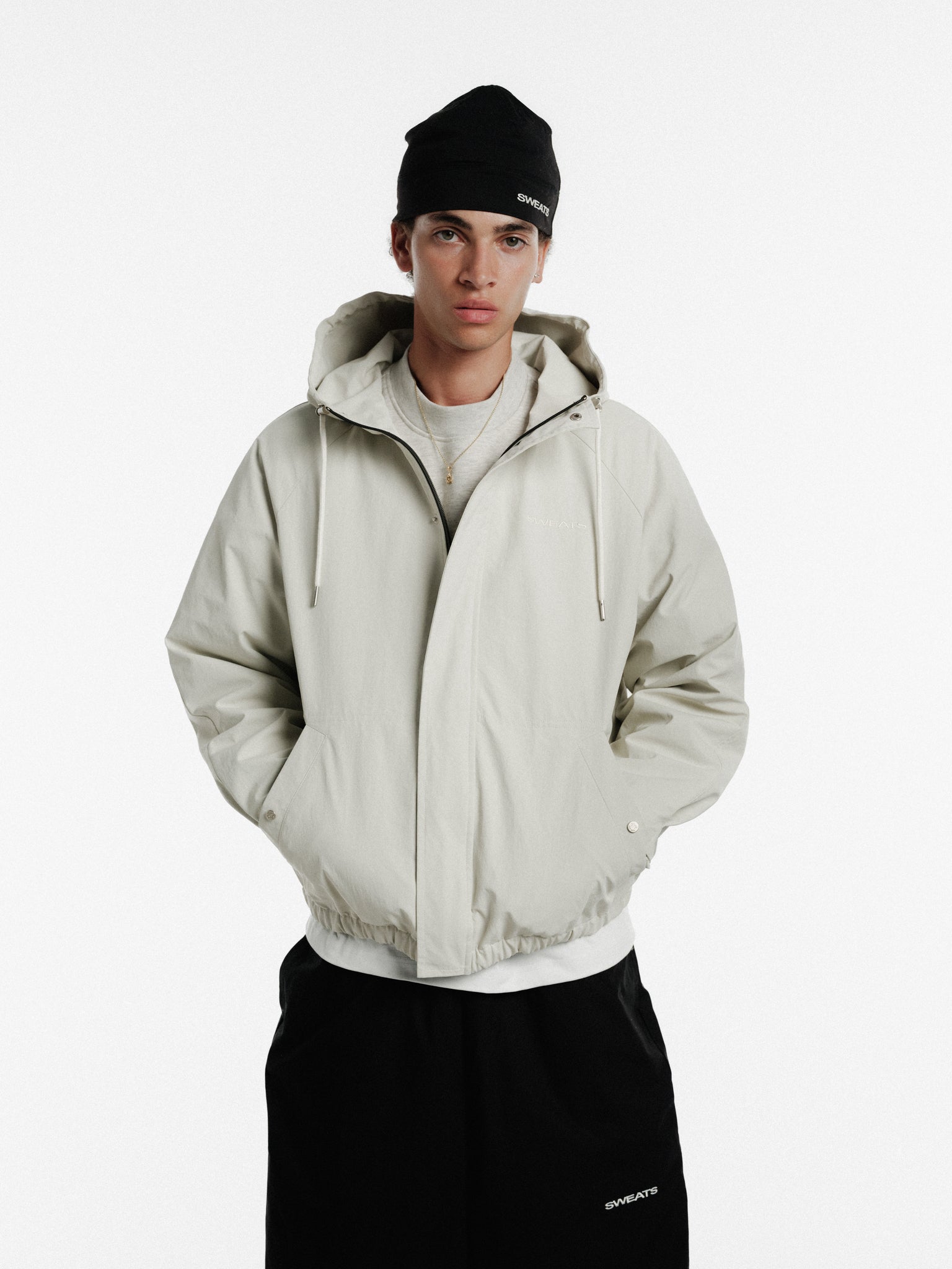 Stone-colored ARC jacket from SWEATS EU with a stylish winter design, featuring a comfortable fit and modern details.