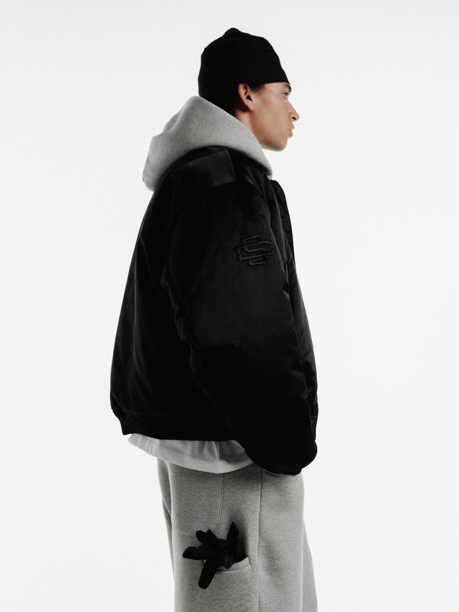 Black bomber jacket by SWEATS EU, featuring a stylish, padded design with ribbed cuffs and collar, ideal for winter wear.