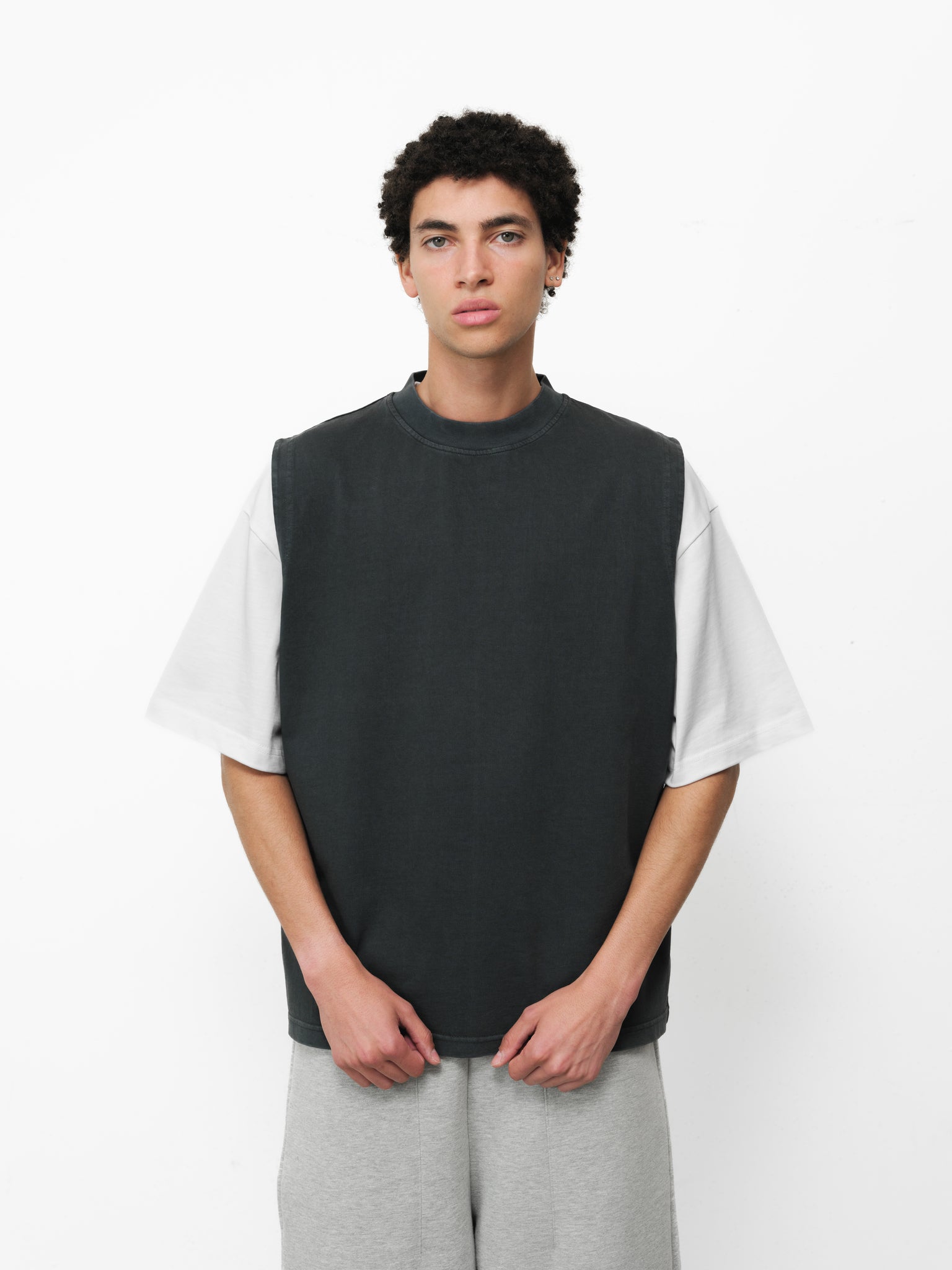 Black washed muscle tee from SWEATS EU, front view showing relaxed fit and soft fabric in a full stock photo.