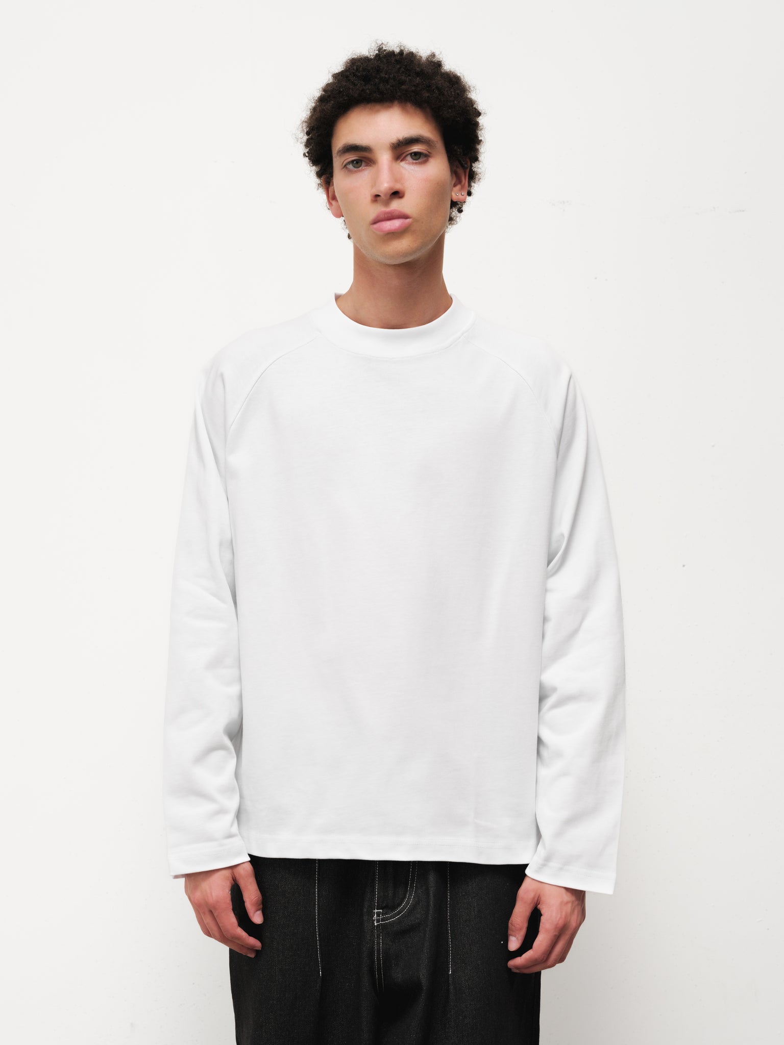 White long sleeve T-shirt by Sweats EU displayed on a model, showcasing a casual fit and soft fabric.