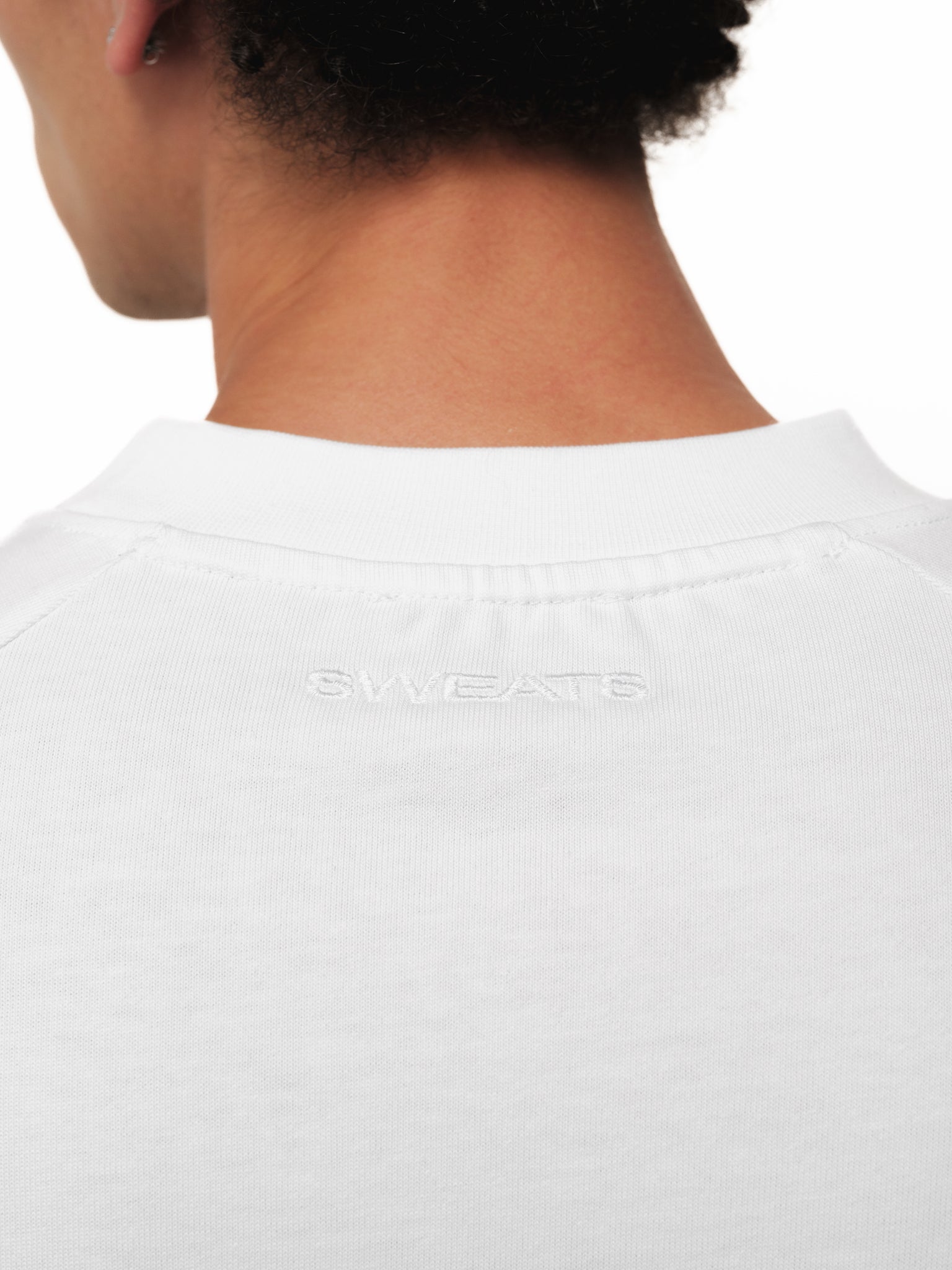 White long sleeve T-shirt by Sweats EU displayed on a model, showcasing a casual fit and soft fabric.