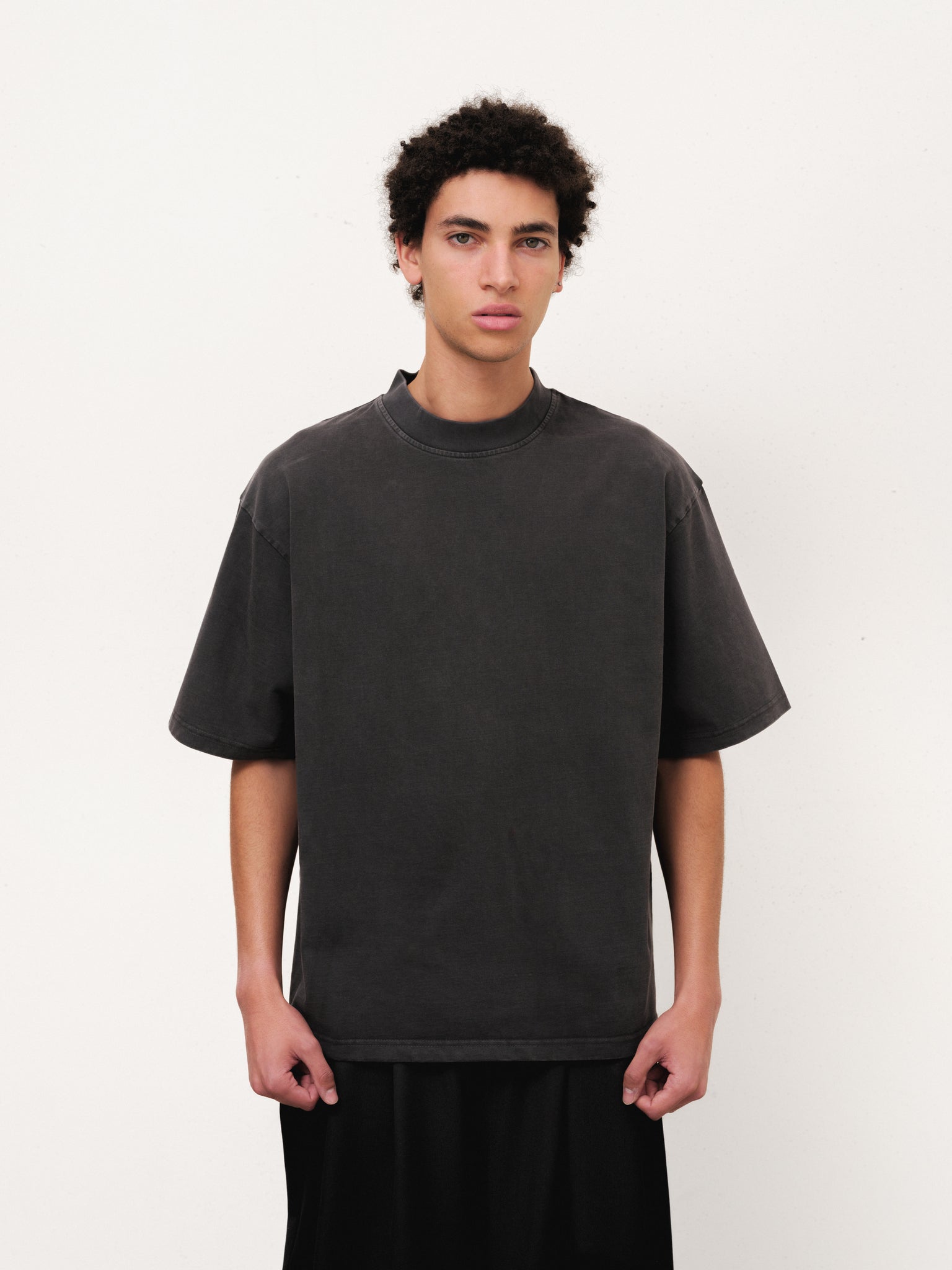 Sweats EU Signature Blank T-Shirt in washed black, displayed on a hanger with a full stock shoot background.