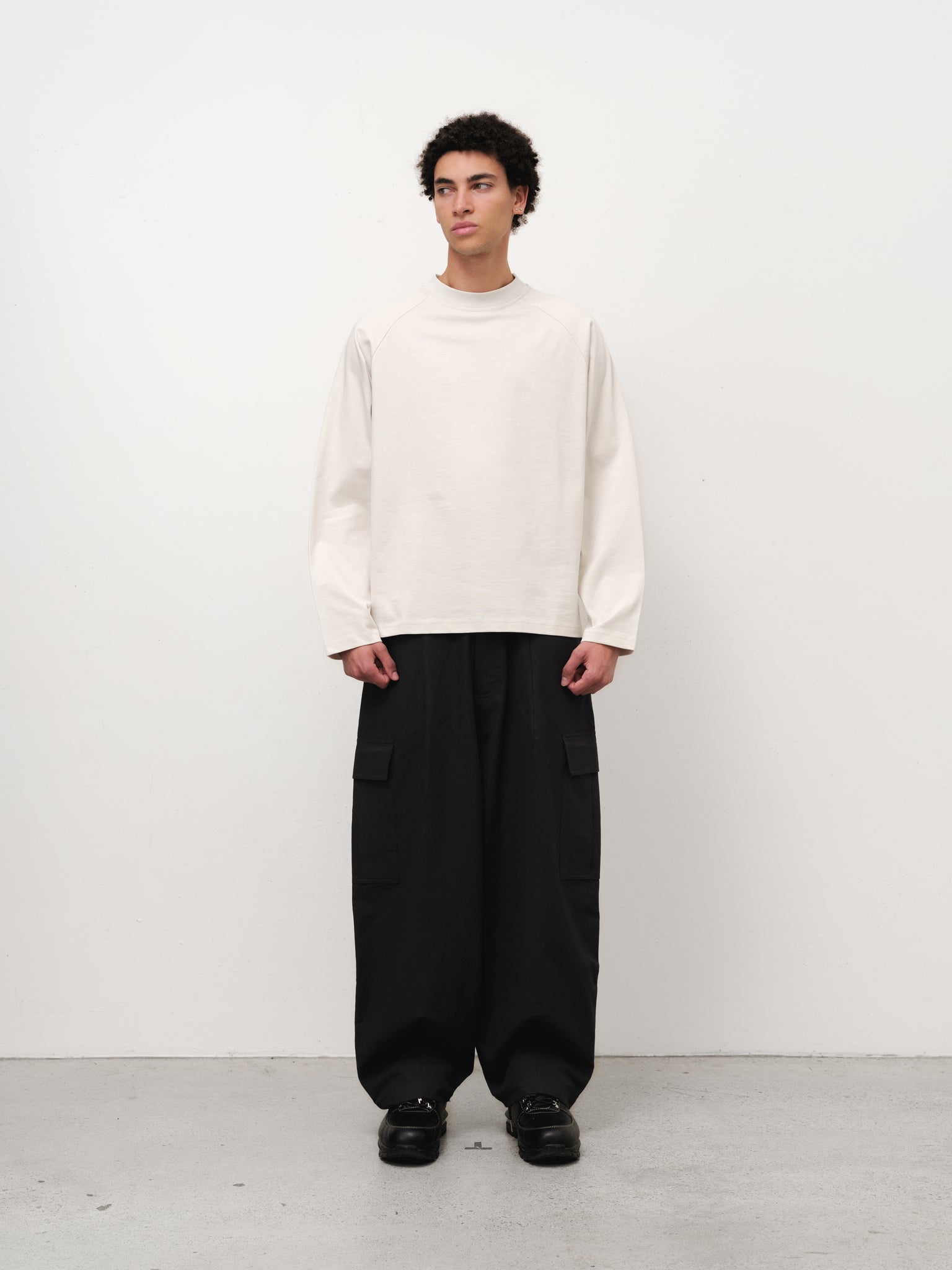 Long sleeve chalk-colored T-shirt by SWEATS EU displayed on a model in a full stock shoot.