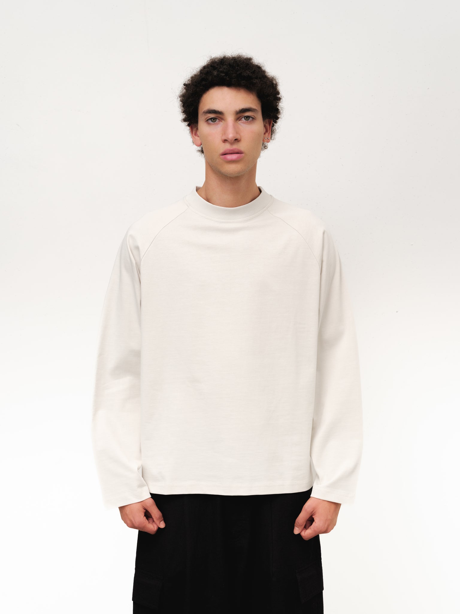 Long sleeve chalk-colored T-shirt from SWEATS EU, shown flat with front view and visible neckline details.
