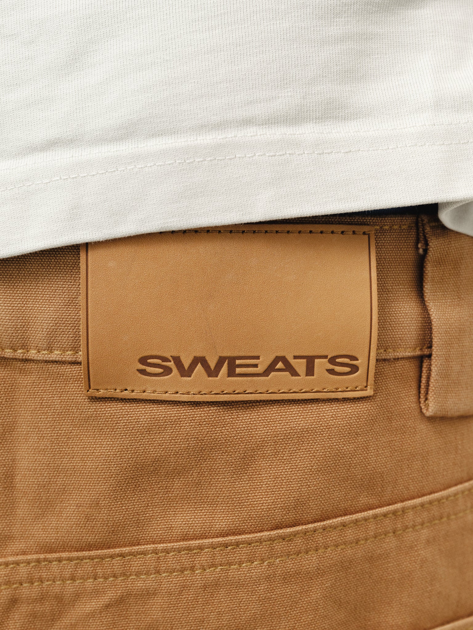 Tan workwear shorts by SWEATS EU, featuring durable fabric and practical design, ideal for industrial or casual work settings.