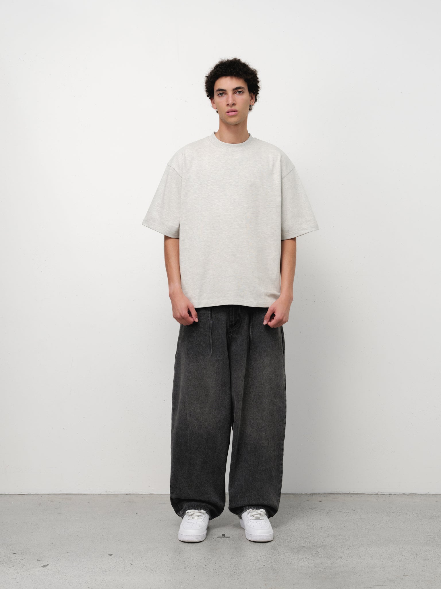 Washed black denim baggy jeans by SWEATS EU, shown on a full-length model with a relaxed fit and casual style.