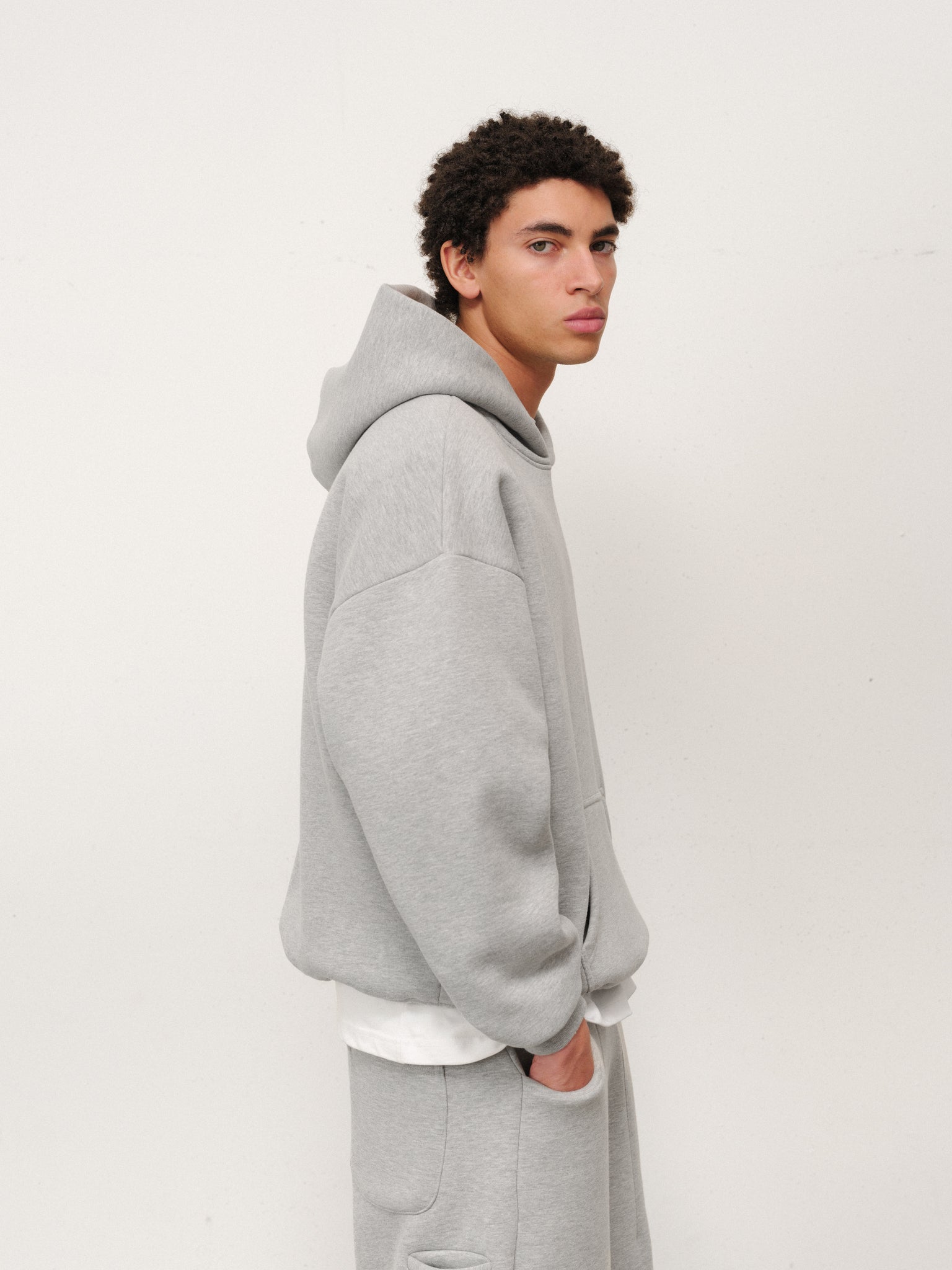 Gray Cozy Hoodie from Sweats EU, featuring a comfortable fit and soft material, shown on a model.