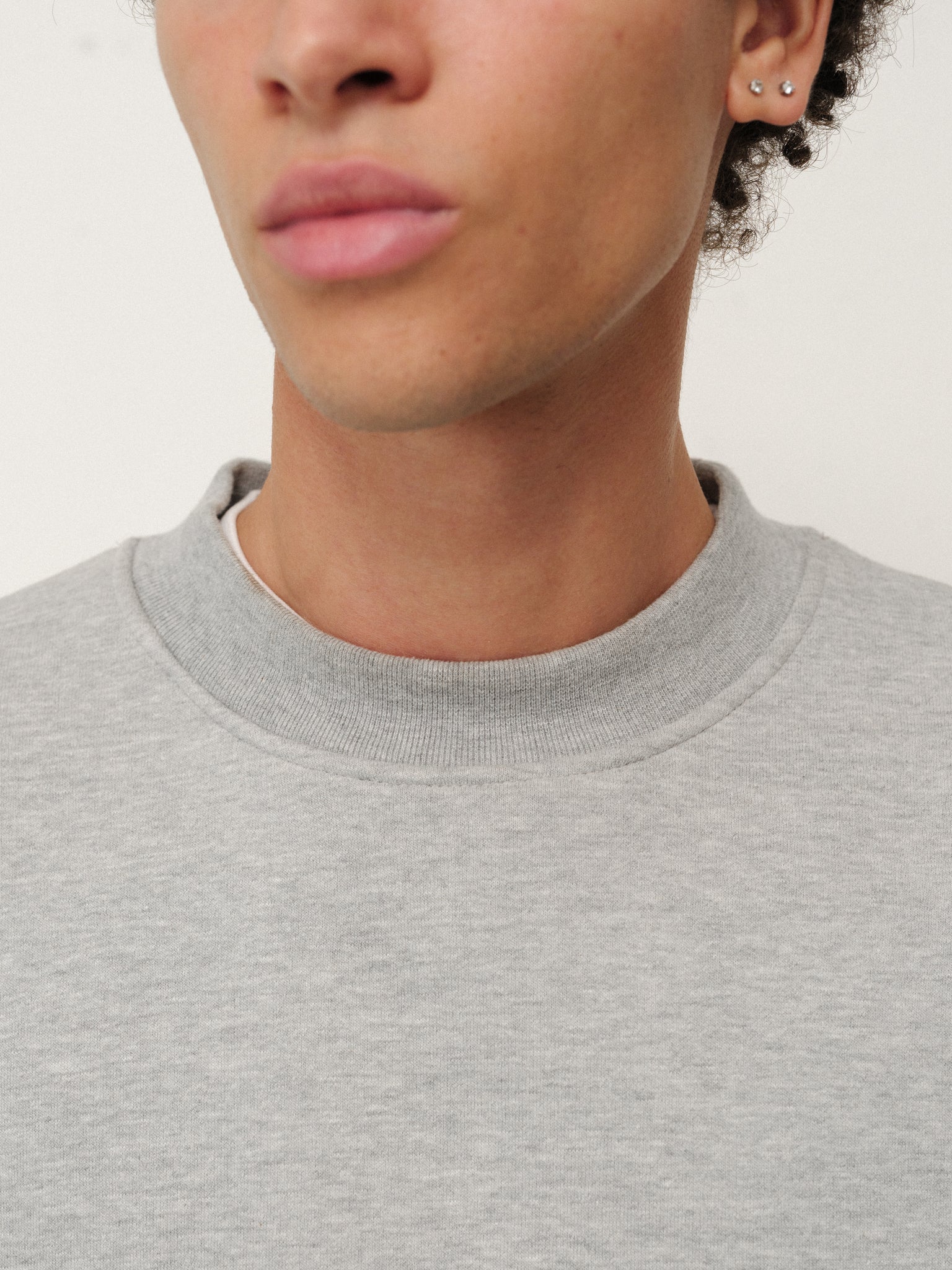 Grey cozy sweater by Sweats EU, featuring a soft knit fabric and classic fit, perfect for casual wear.