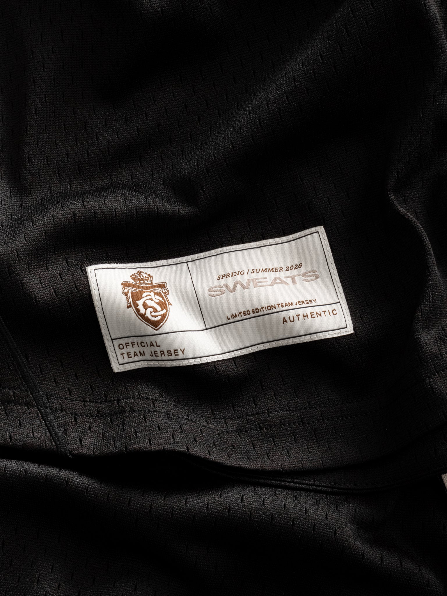 Black baseball jersey by SWEATS EU, showing front view with button details and team logo on the chest.