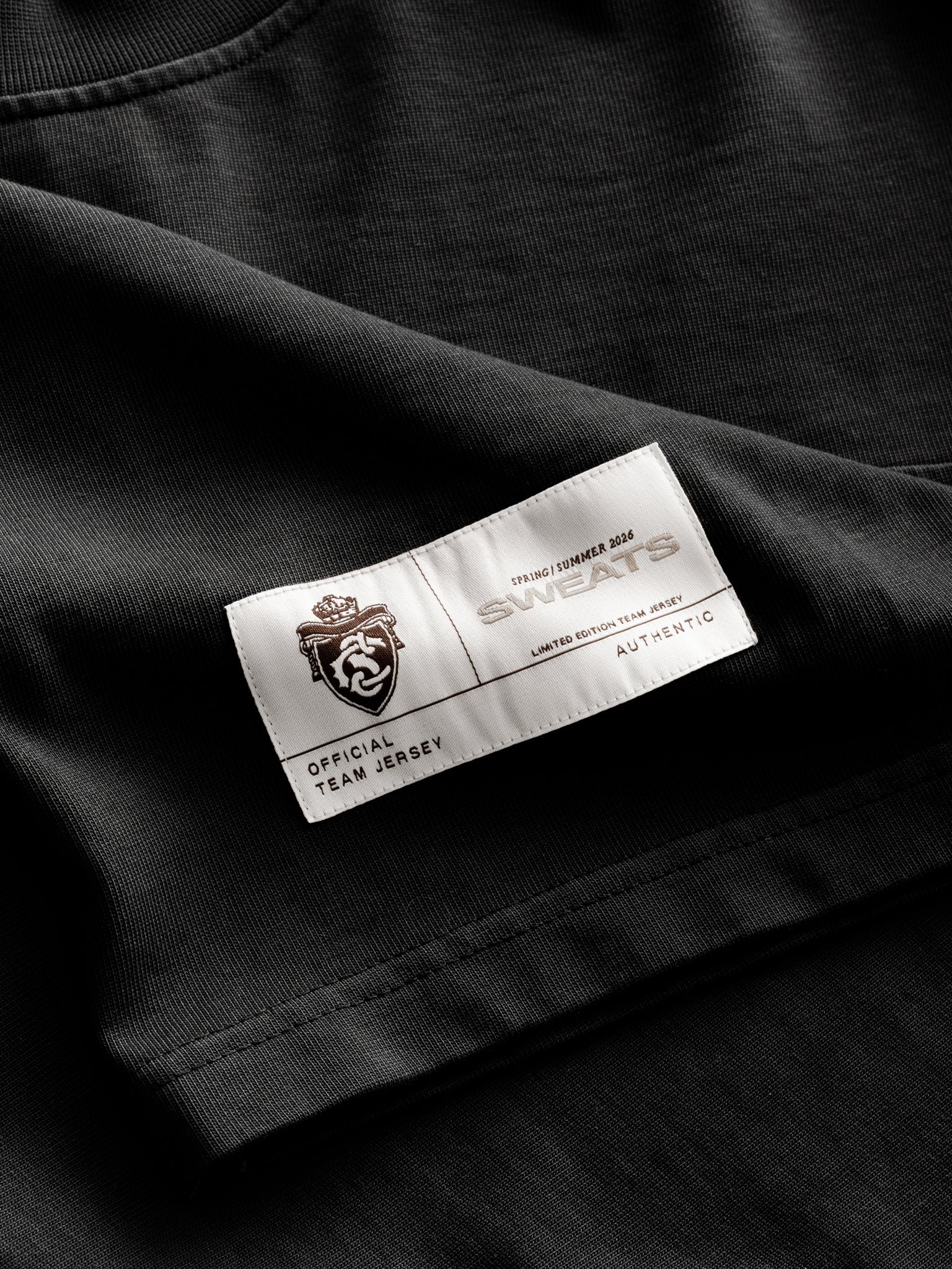 Washed black long-sleeve jersey T-shirt by SWEATS EU displayed flat with soft fabric texture and classic crew neckline.