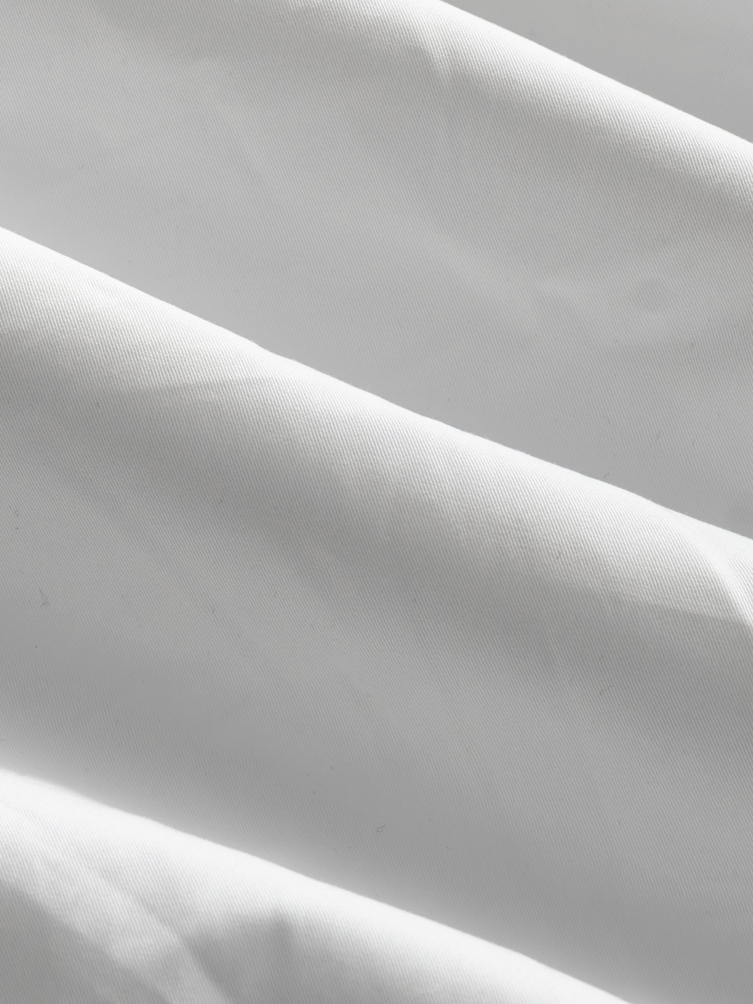 White V3 Flight Shorts by SWEATS EU laid flat, showing the lightweight fabric, elastic waistband, and clean design.
