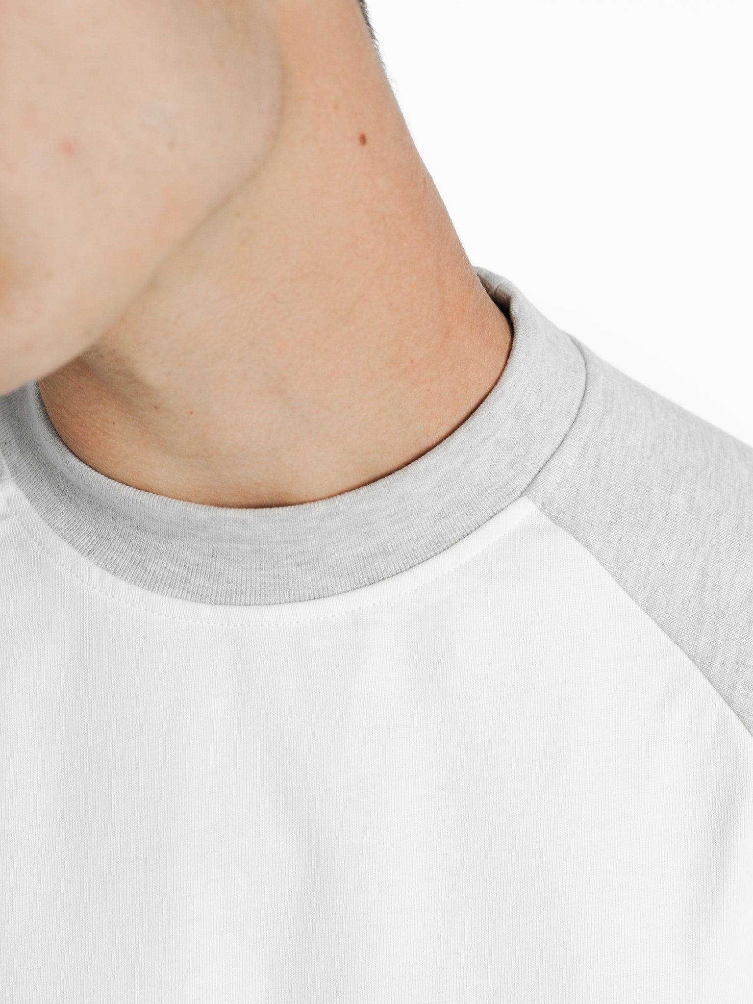 White and Arctic blue raglan short-sleeve T-shirt from SWEATS EU, shown on a model in a lookbook image.
