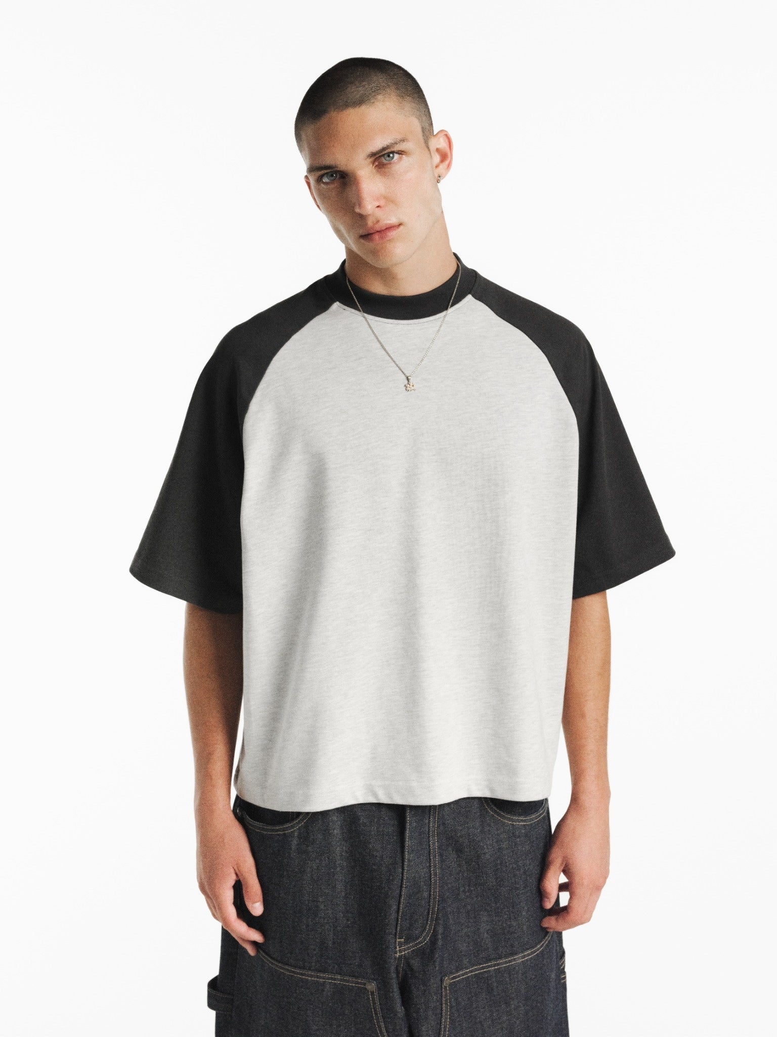 Light gray and navy raglan short-sleeve T-shirt from SWEATS EU with contrasting sleeves, casual fit, and minimal branding.