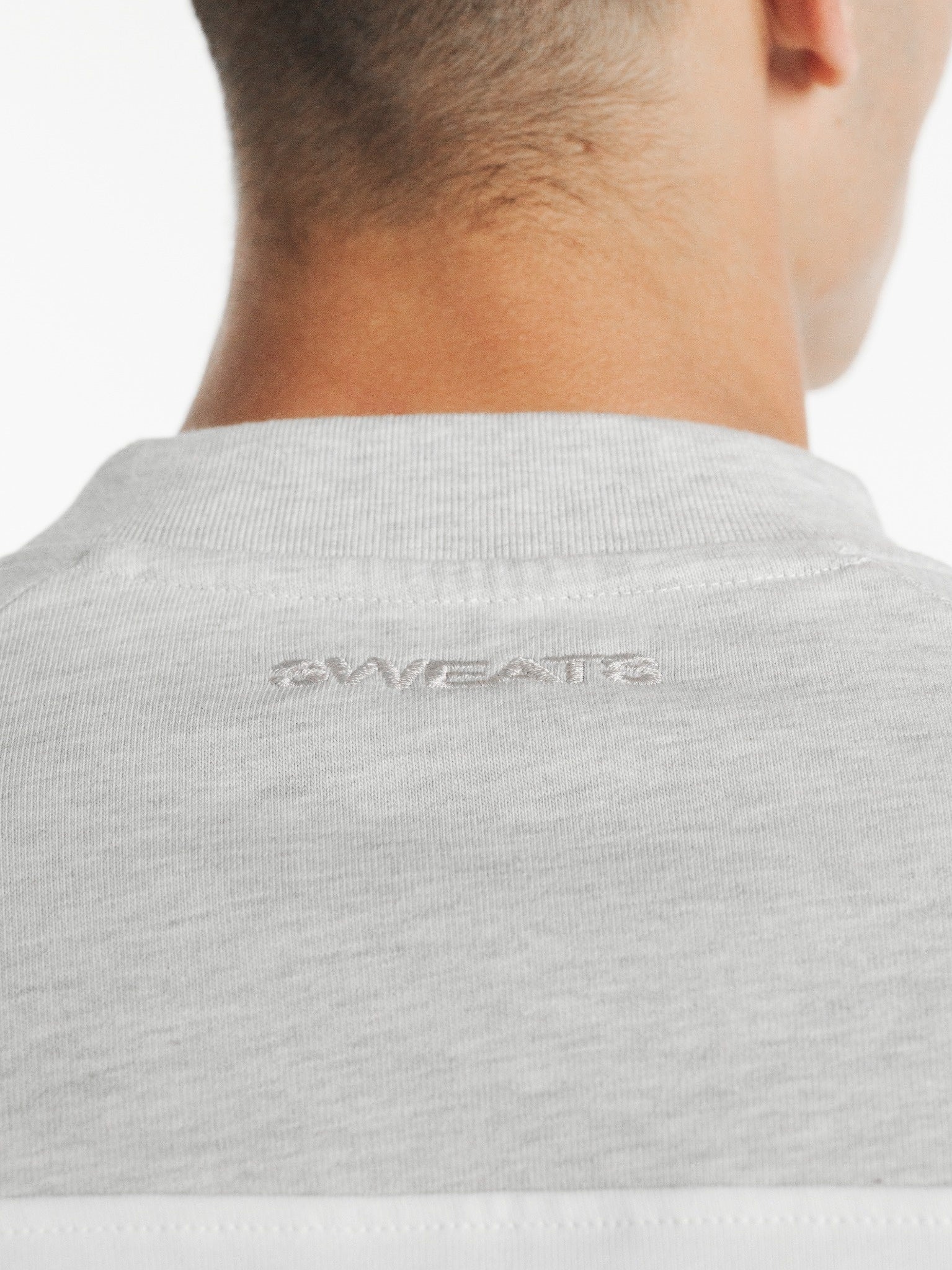 White and Arctic blue raglan long-sleeve T-shirt by SWEATS EU displayed on a model in a fashion lookbook image.