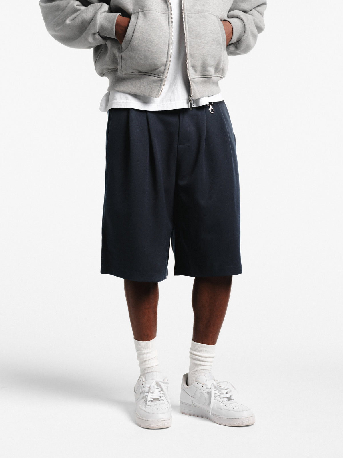 Navy pleated shorts from Sweats EU, featuring a stylish design and comfortable fit, displayed on a plain background.