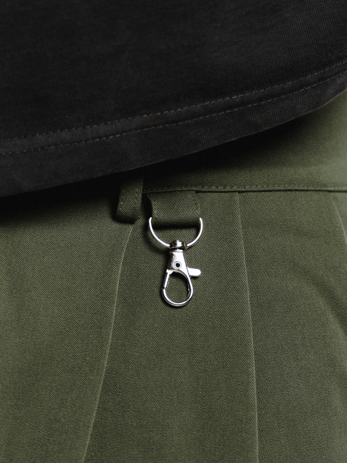 Olive pleated shorts by SWEATS EU, featuring a stylish design with pleats and a comfortable fit.