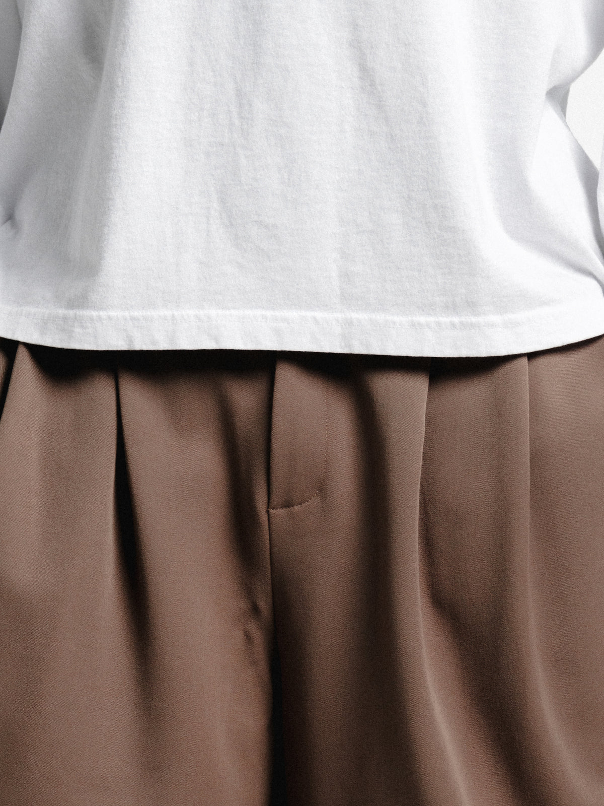 Brown pleated shorts from Sweats EU, featuring a stylish, tailored design with a comfortable fit and pleated front detail.