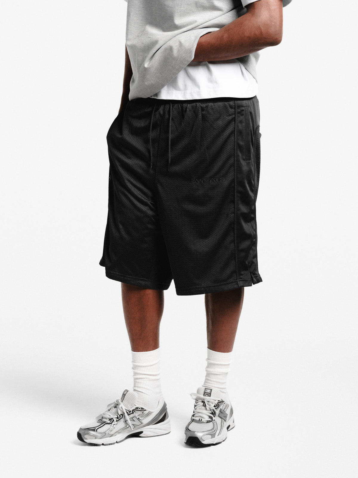 Black mesh shorts by SWEATS EU, featuring breathable fabric and a relaxed fit, ideal for athletic or casual wear.