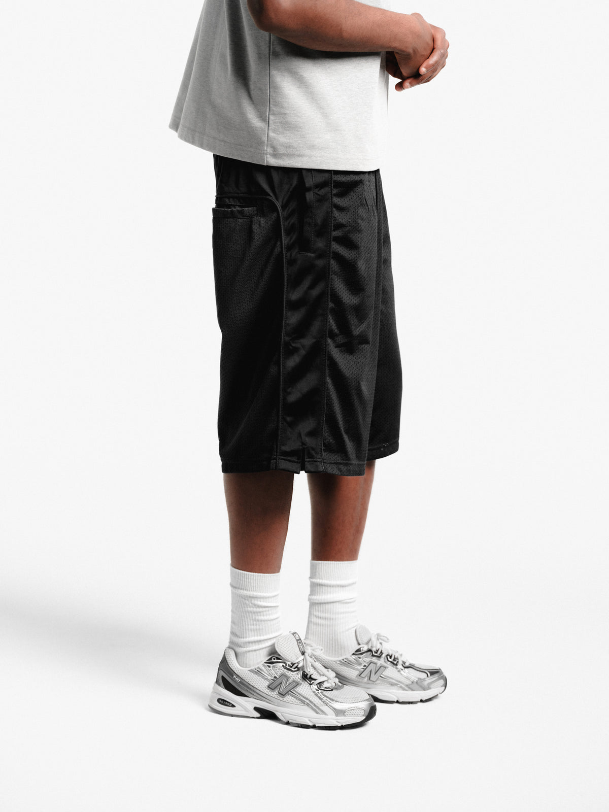Black mesh shorts by SWEATS EU, lightweight athletic shorts with breathable mesh fabric and an elastic waistband.