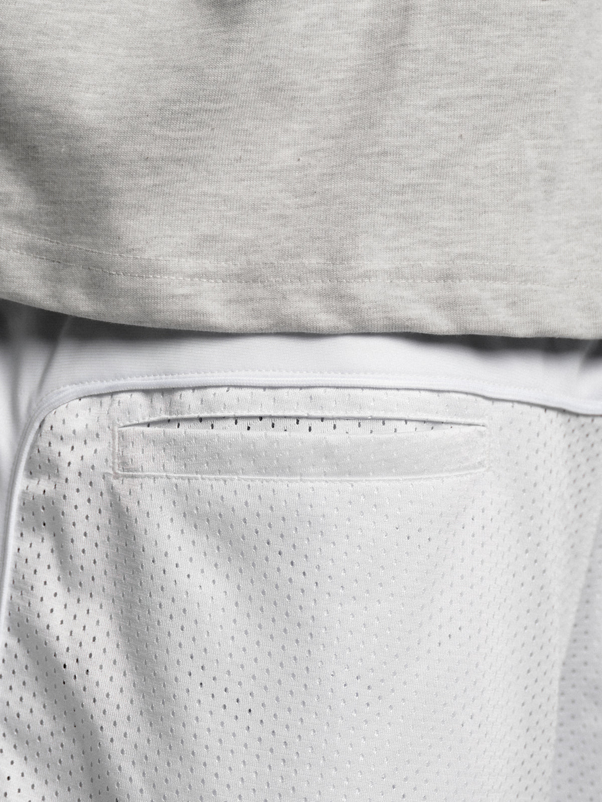White mesh shorts by SWEATS EU featuring breathable fabric and a relaxed fit, ideal for athletic or casual wear.