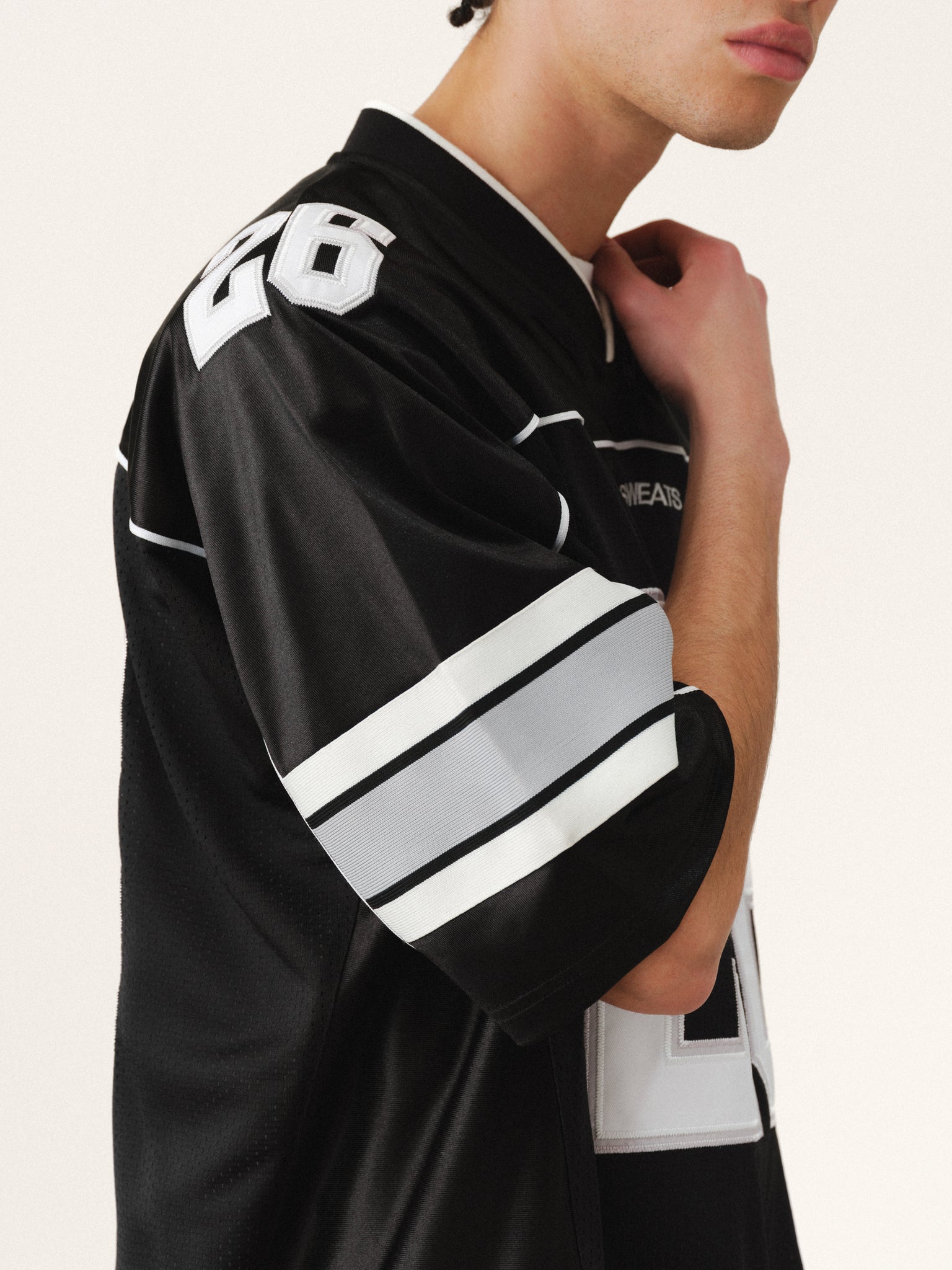 Black Signature Jersey by SWEATS EU, showcasing a sleek, fitted design with subtle branding and comfortable fabric.