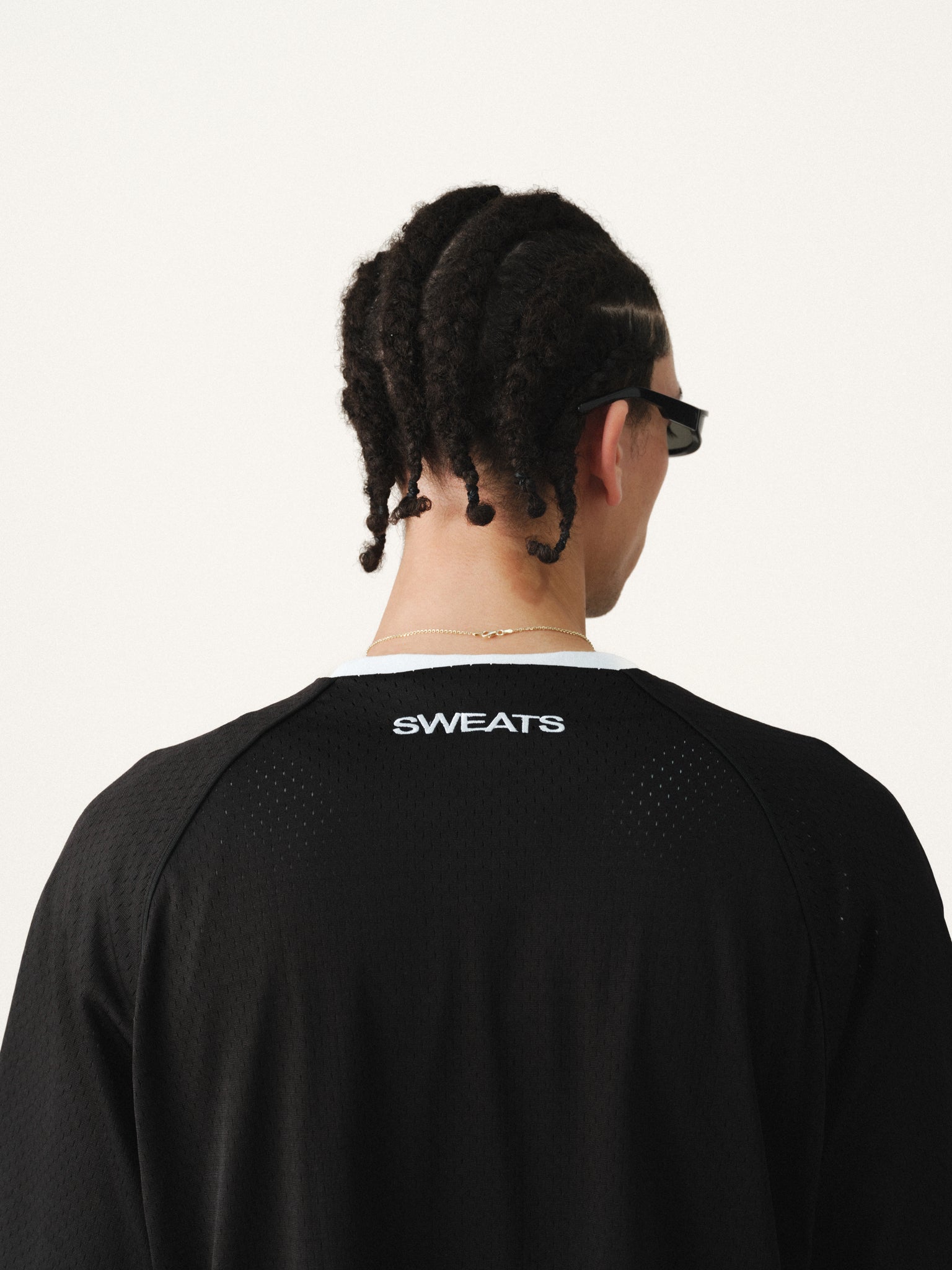 Black baseball jersey by SWEATS EU displayed on a hanger, featuring team logo and classic athletic design.
