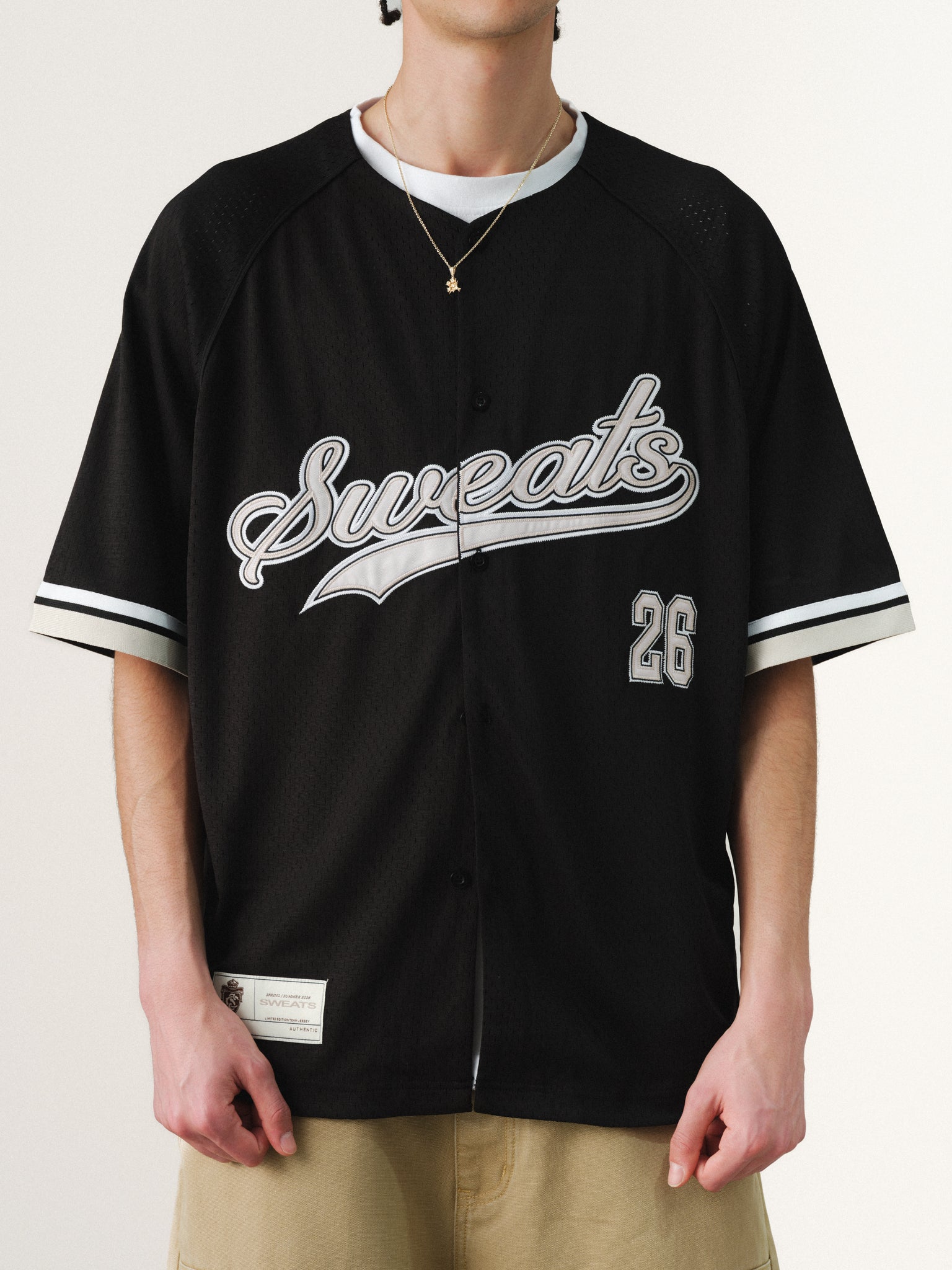 Black baseball jersey by SWEATS EU featuring classic design and comfortable fabric, displayed on a hanger.