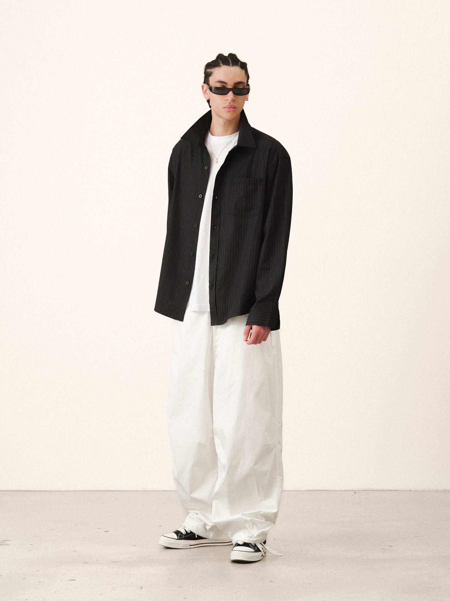 Black striped button-up shirt by SWEATS EU, featuring a classic collar and button-front design, displayed on a hanger.