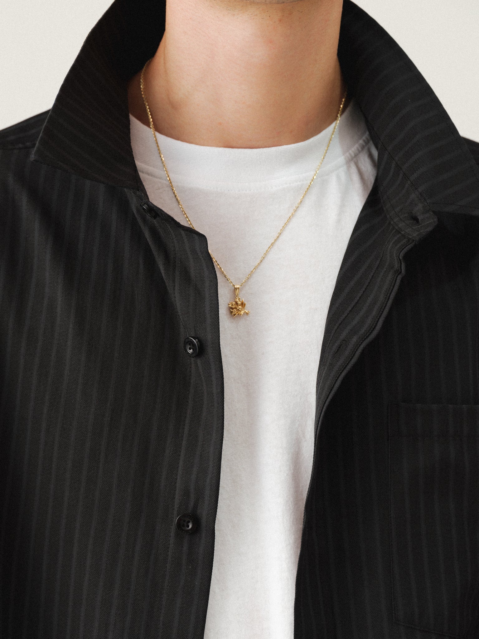 Black striped button-up shirt by Sweats EU, featuring a classic collar and long sleeves, shown on a hanger against a plain background.
