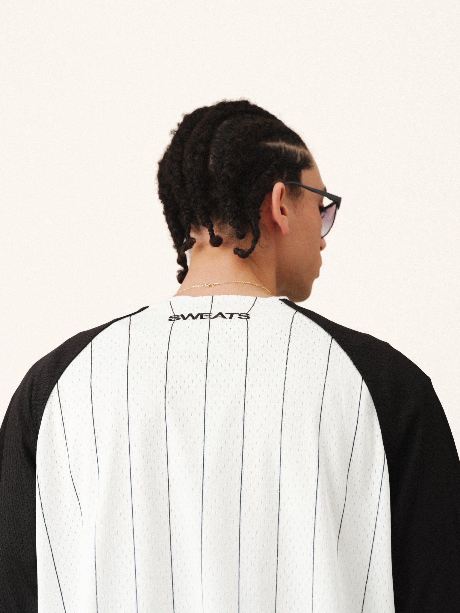 White pinstripe baseball jersey by SWEATS EU with button-up front and team logo detail, casual athletic style.