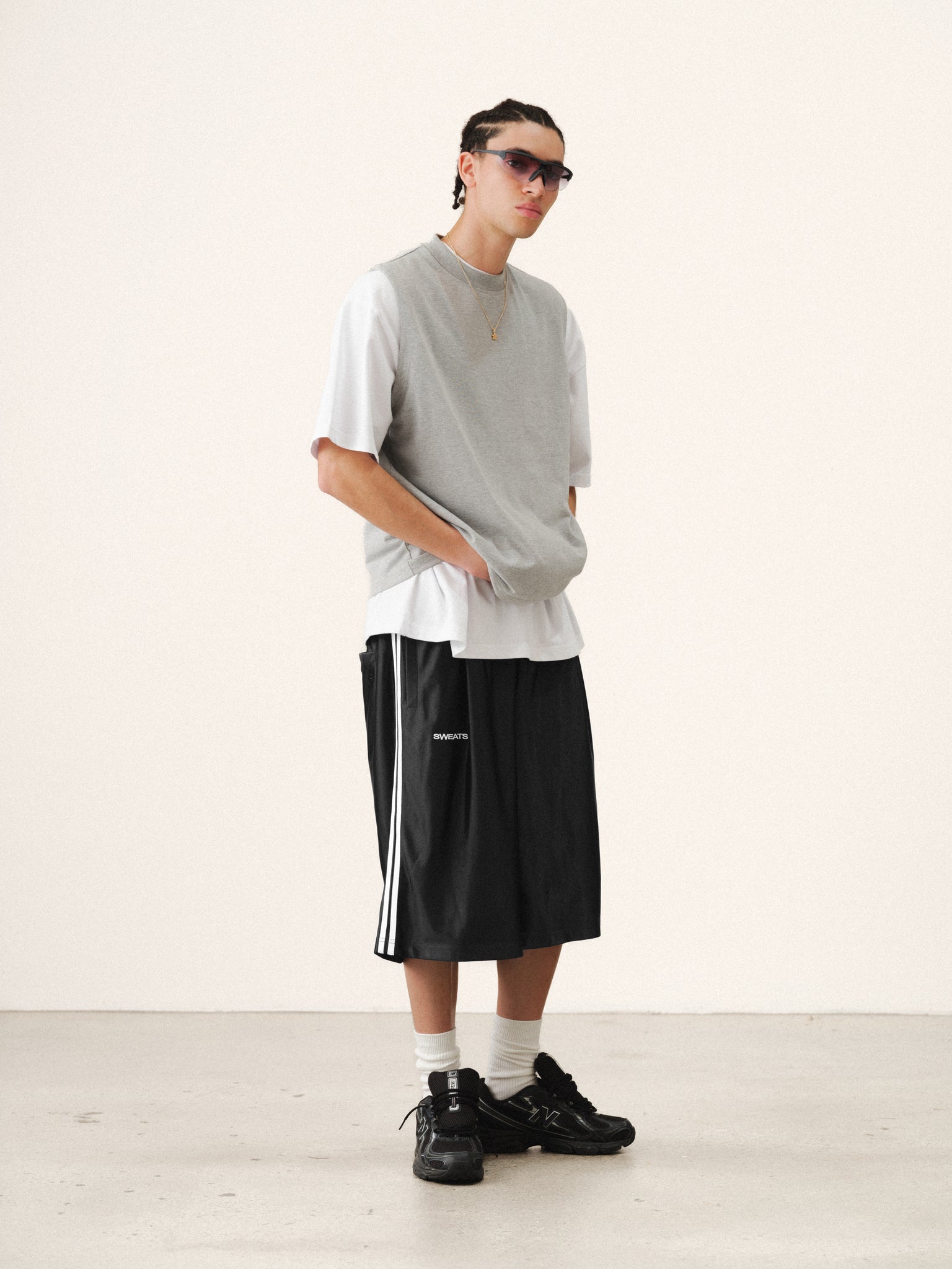 Black League Shorts by SWEATS EU, casual athletic shorts with a comfortable fit, shown in a relaxed summer setting.