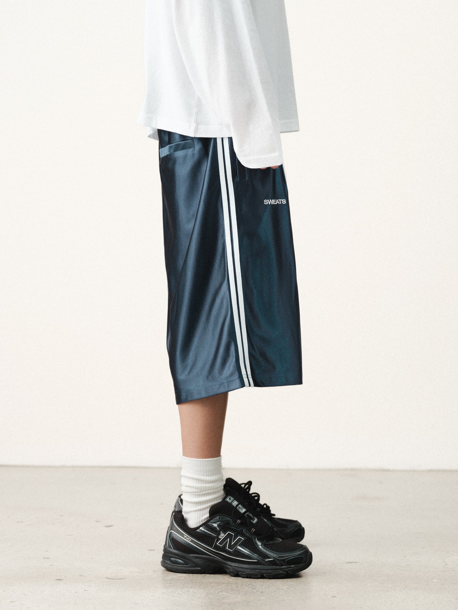 Navy League shorts by SWEATS EU shown on a hanger, featuring a relaxed fit and casual summer style.
