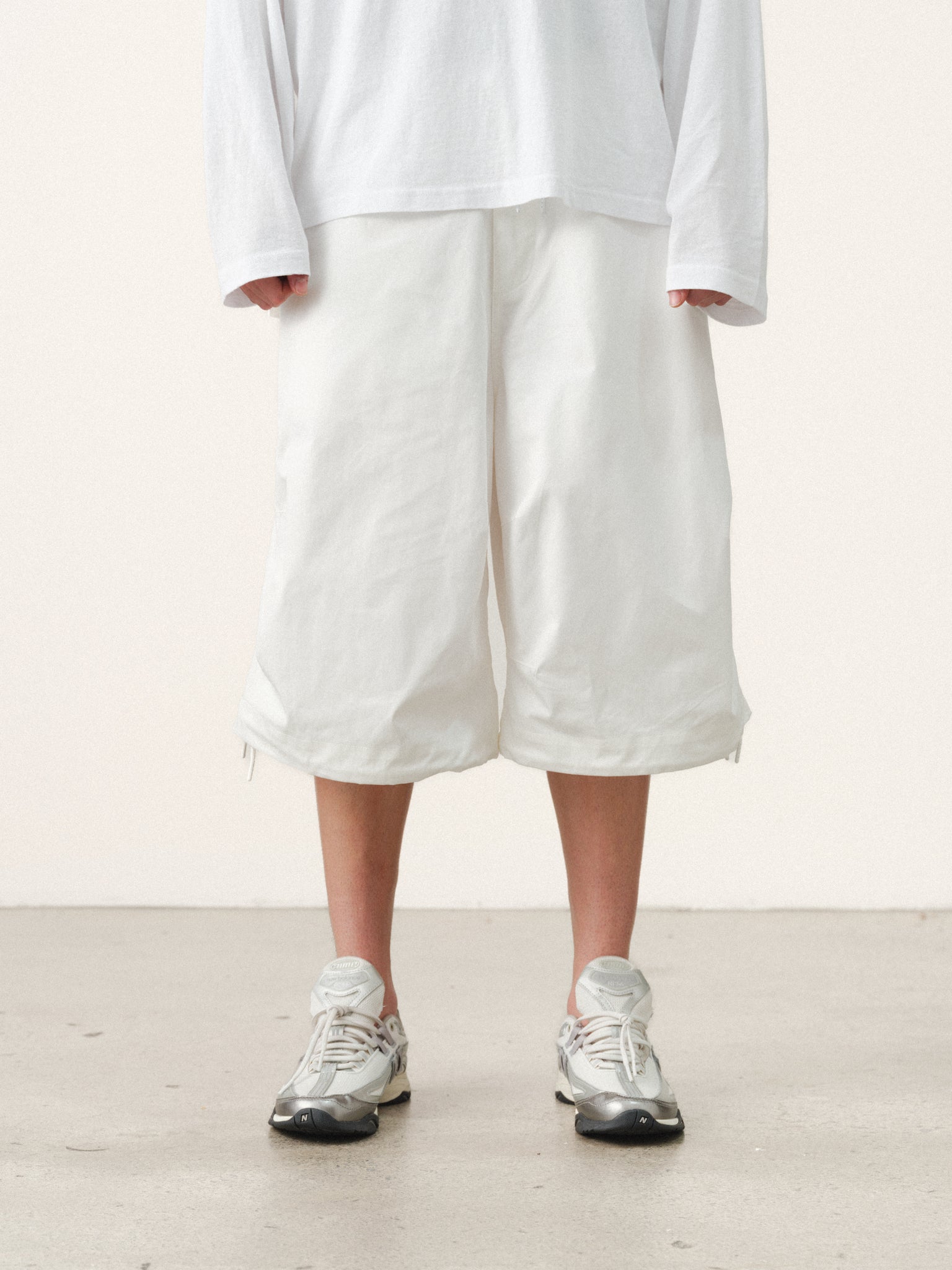 White V3 Flight Shorts by SWEATS EU displayed on a model, featuring a relaxed fit and modern design for active summer wear.
