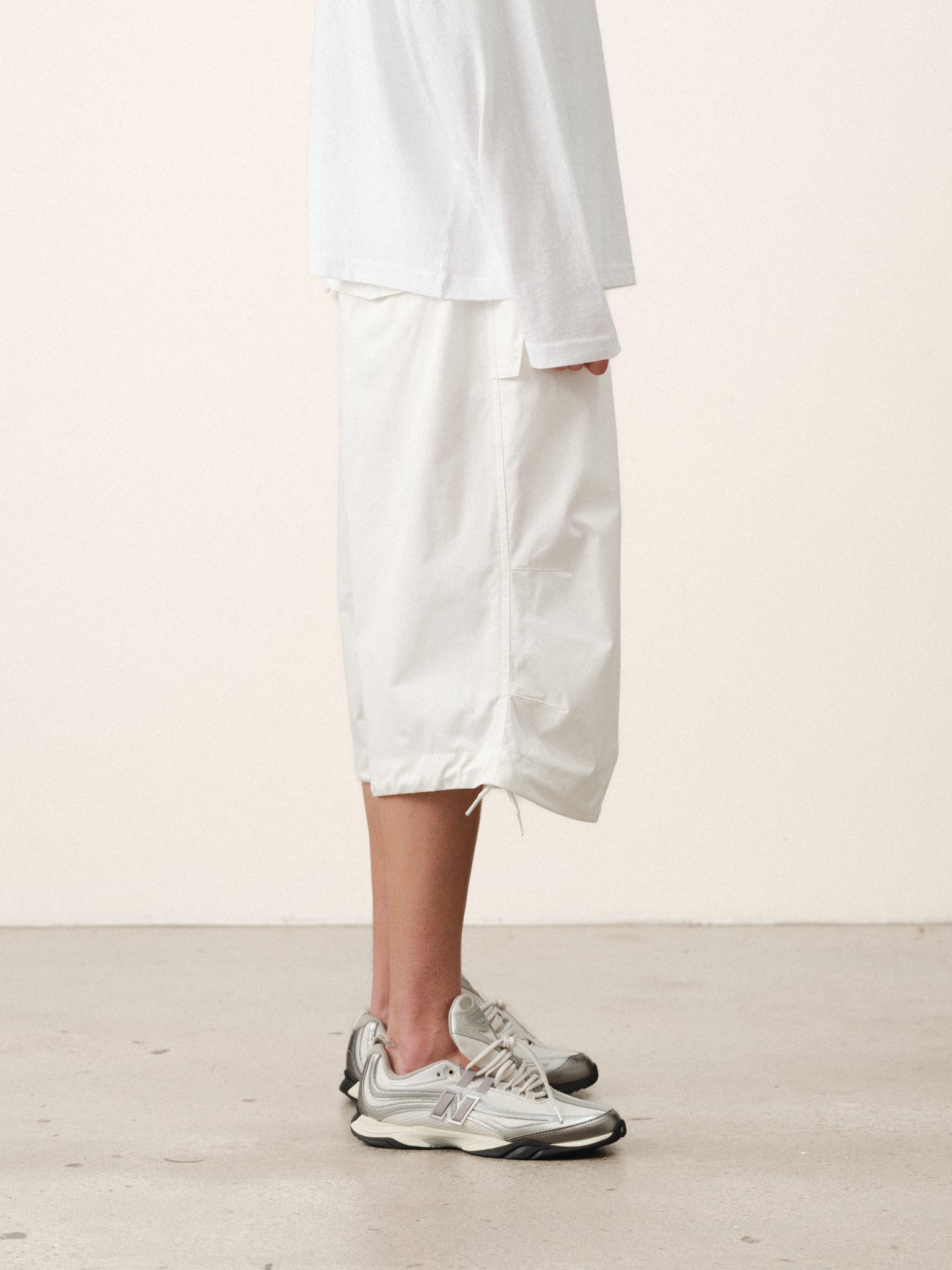 White V3 Flight Shorts by SWEATS EU displayed on a model, showcasing their sporty design and comfortable fit.