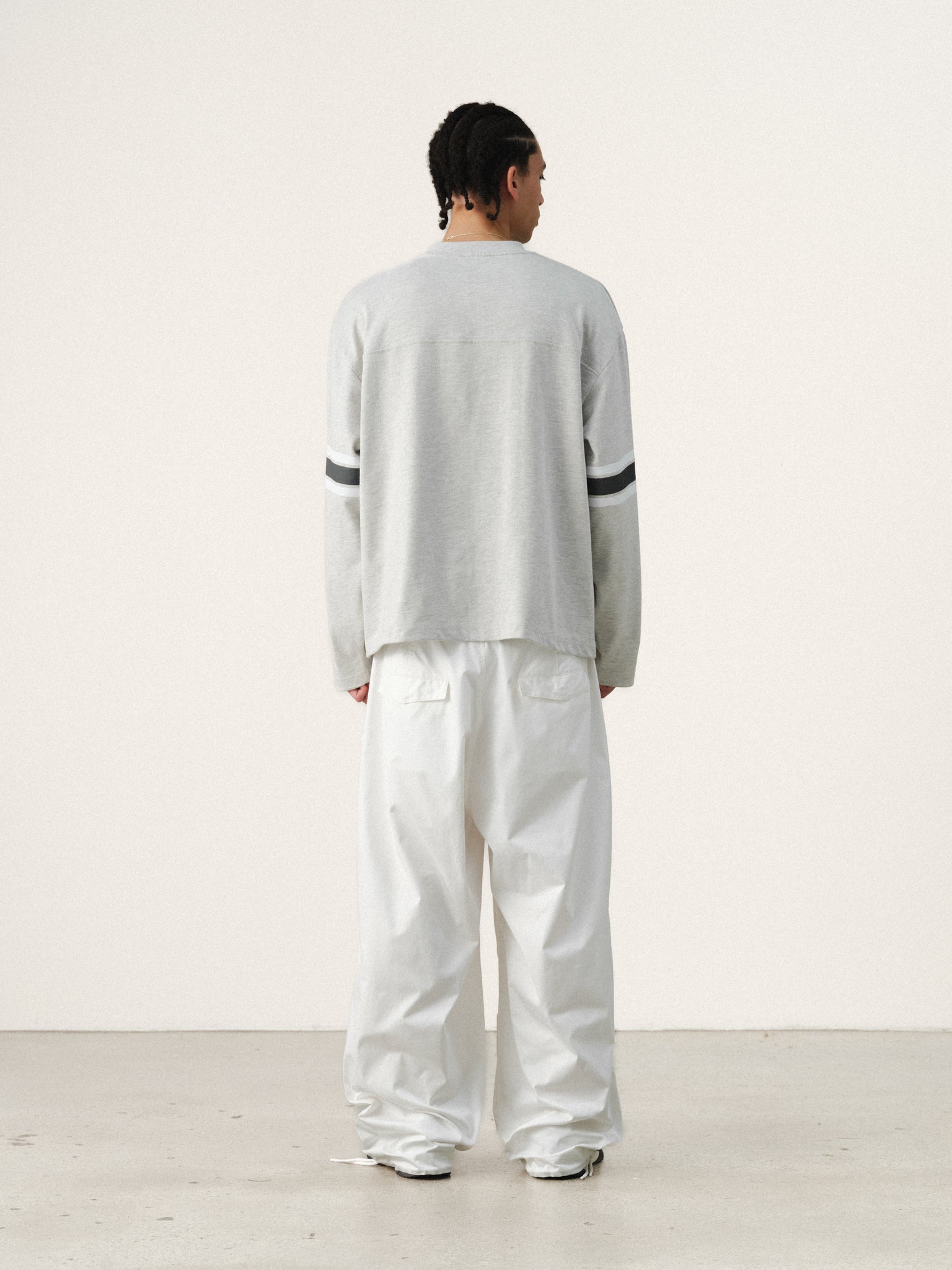 Light blue long-sleeve jersey T-shirt by SWEATS EU, featuring a casual fit and soft fabric, shown on a model.